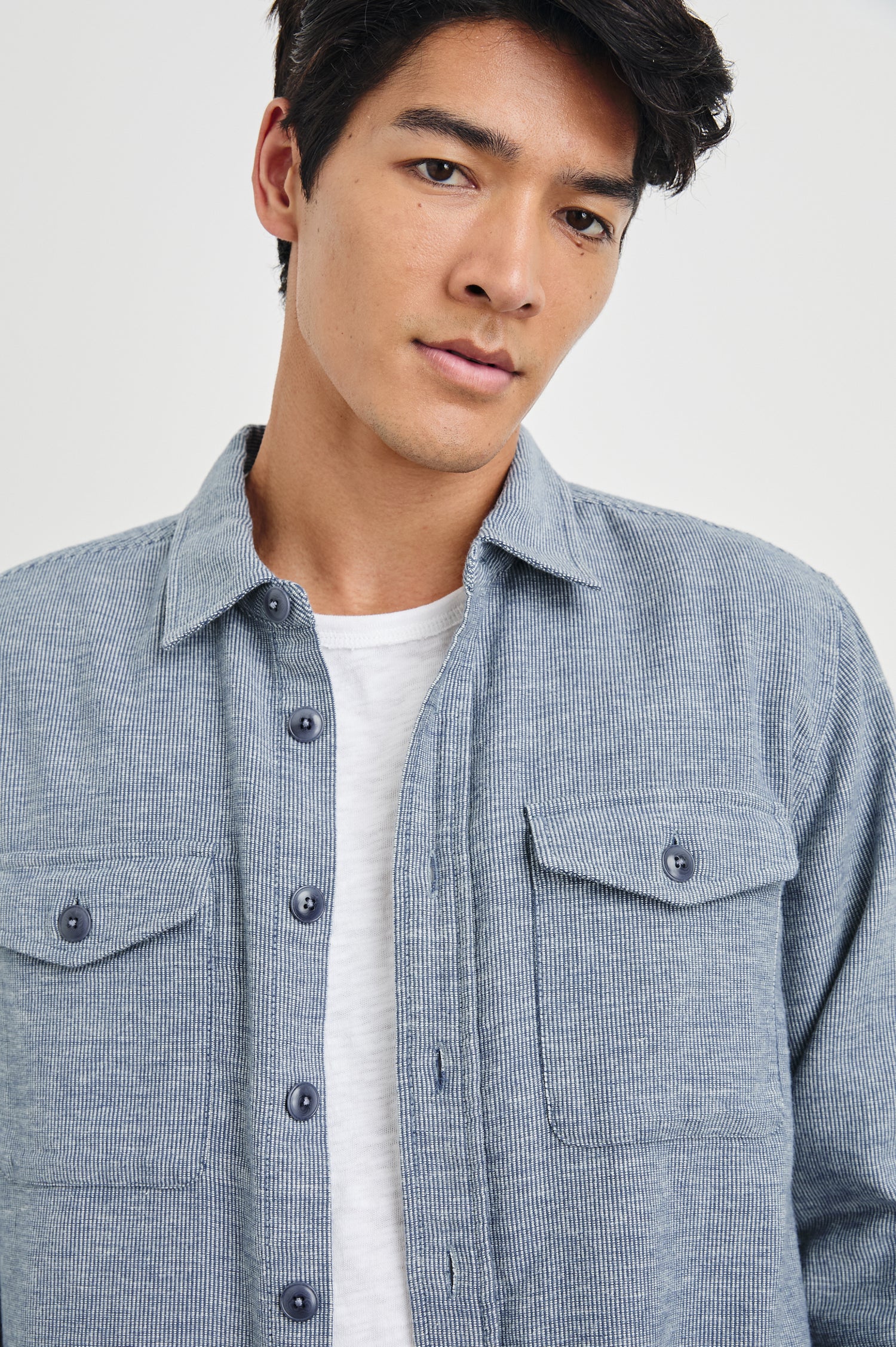 Burr Collared Shirt Jacket with Button Closure, Two Chest Button Flap Pockets and Textured Fabric in Denim White Colorway - Front Unbuttoned View Featured on Model