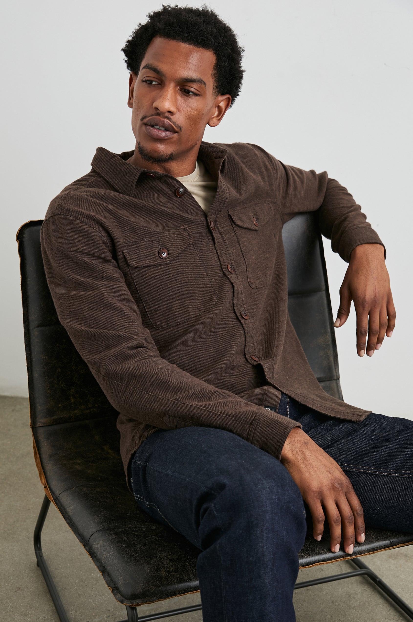 Burr Collared Shirt Jacket with Button Closure, Two Chest Button Flap Pockets and Textured Fabric in Pine Cone Colorway, a Brown - Front Full Body View Featured on Seated Model