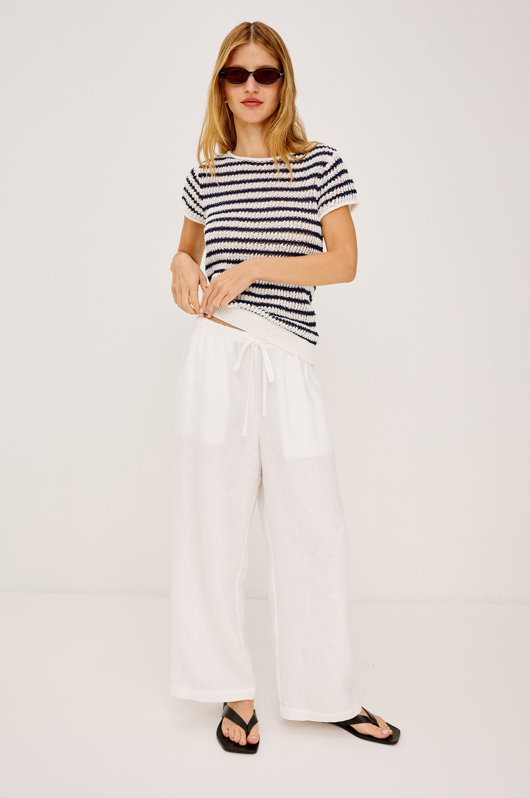 Cady Top in Semi-Sheer Linen-Blend Knit With Rolled Neckline, Cap Sleeves, and Classic Fit in Ivory Indigo Stripe Colorway - Full Body Front View Featured on Model