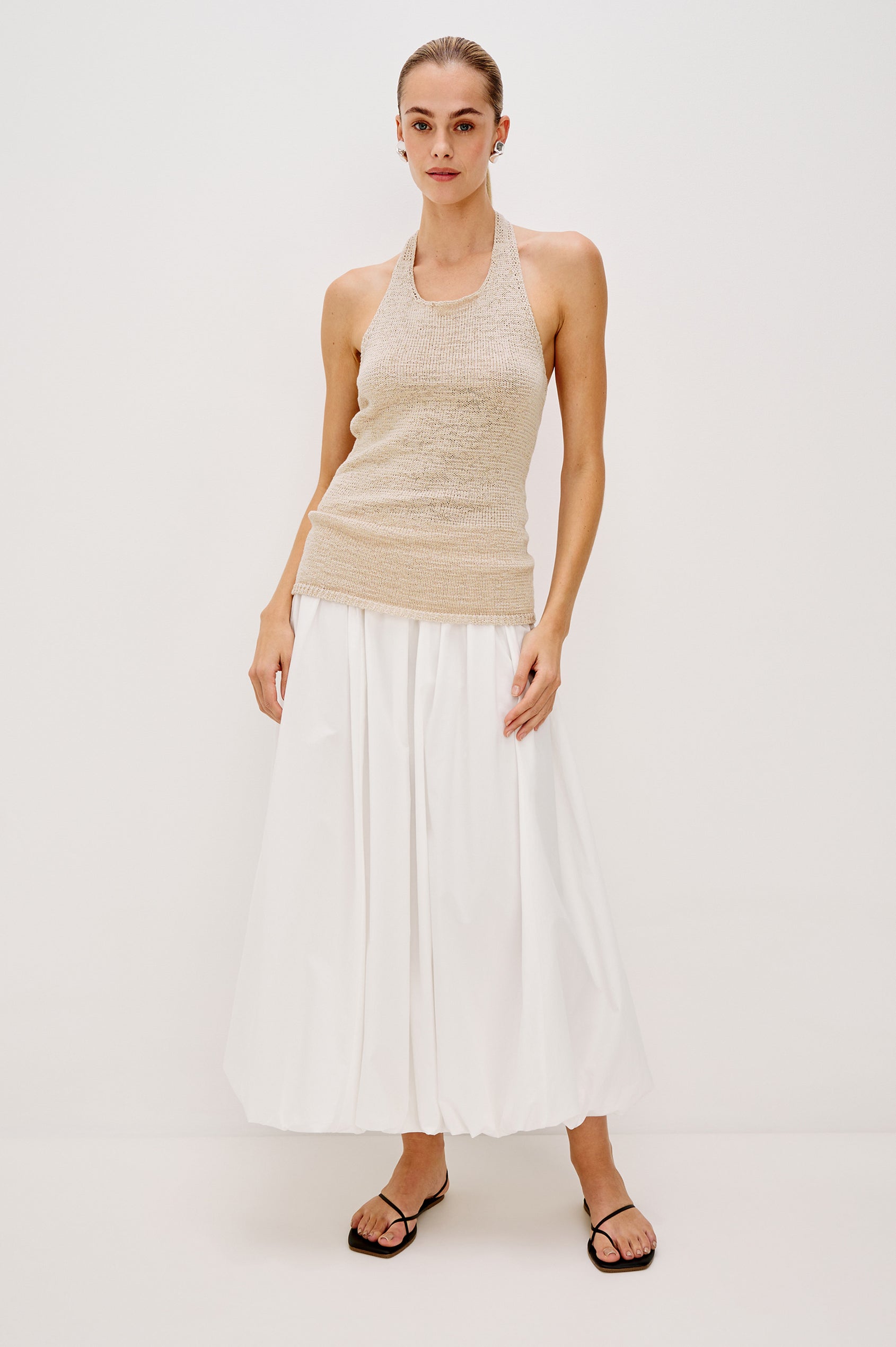 Cala midi length bubble skirt with elastic waistband and side pockets in White Colorway - front view on model.