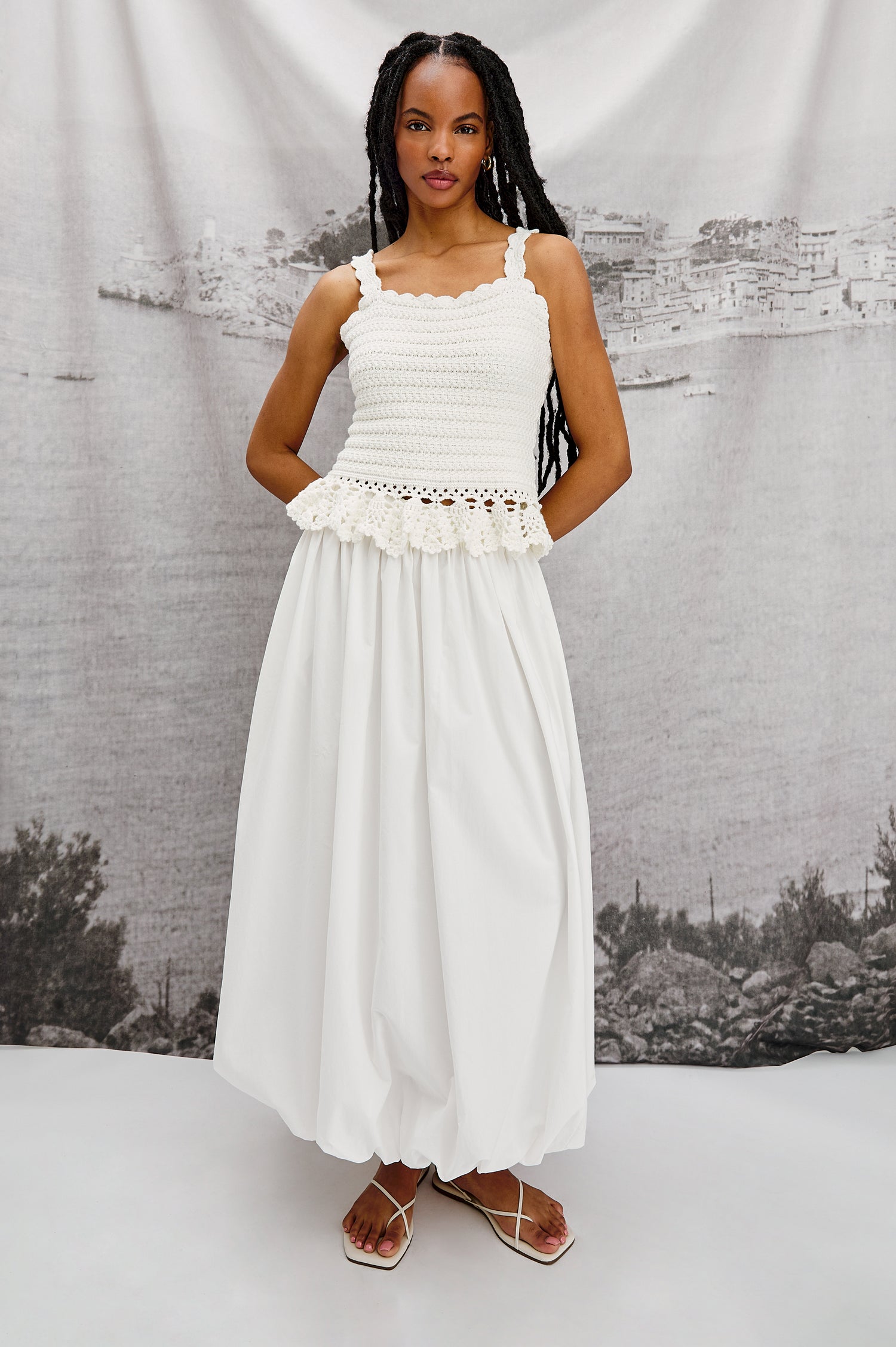 Cala midi length bubble skirt with elastic waistband and side pockets in White Colorway - Stylized full body front view on model.