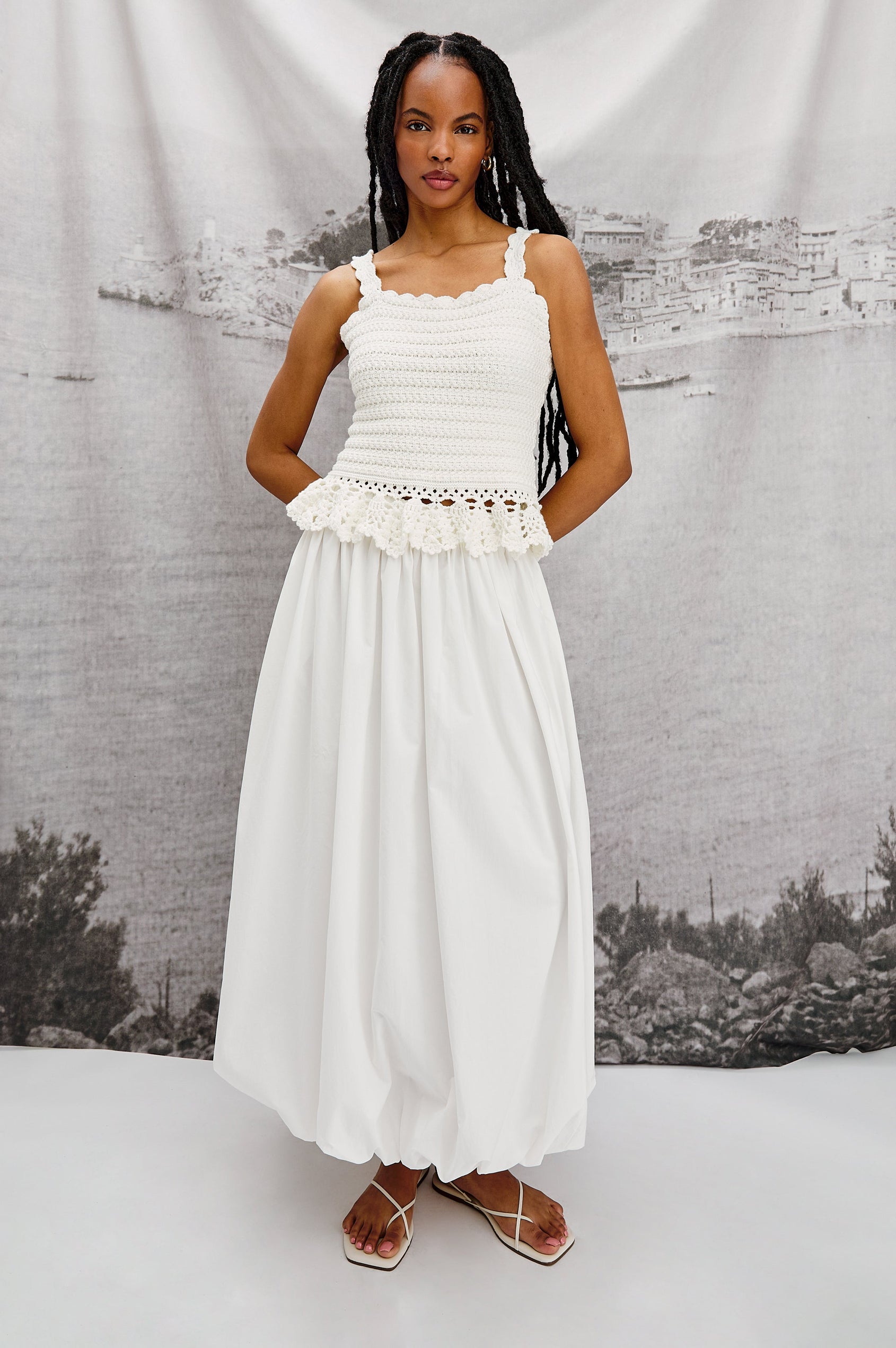 Cala midi length bubble skirt with elastic waistband and side pockets in White Colorway - Stylized full body front view on model.