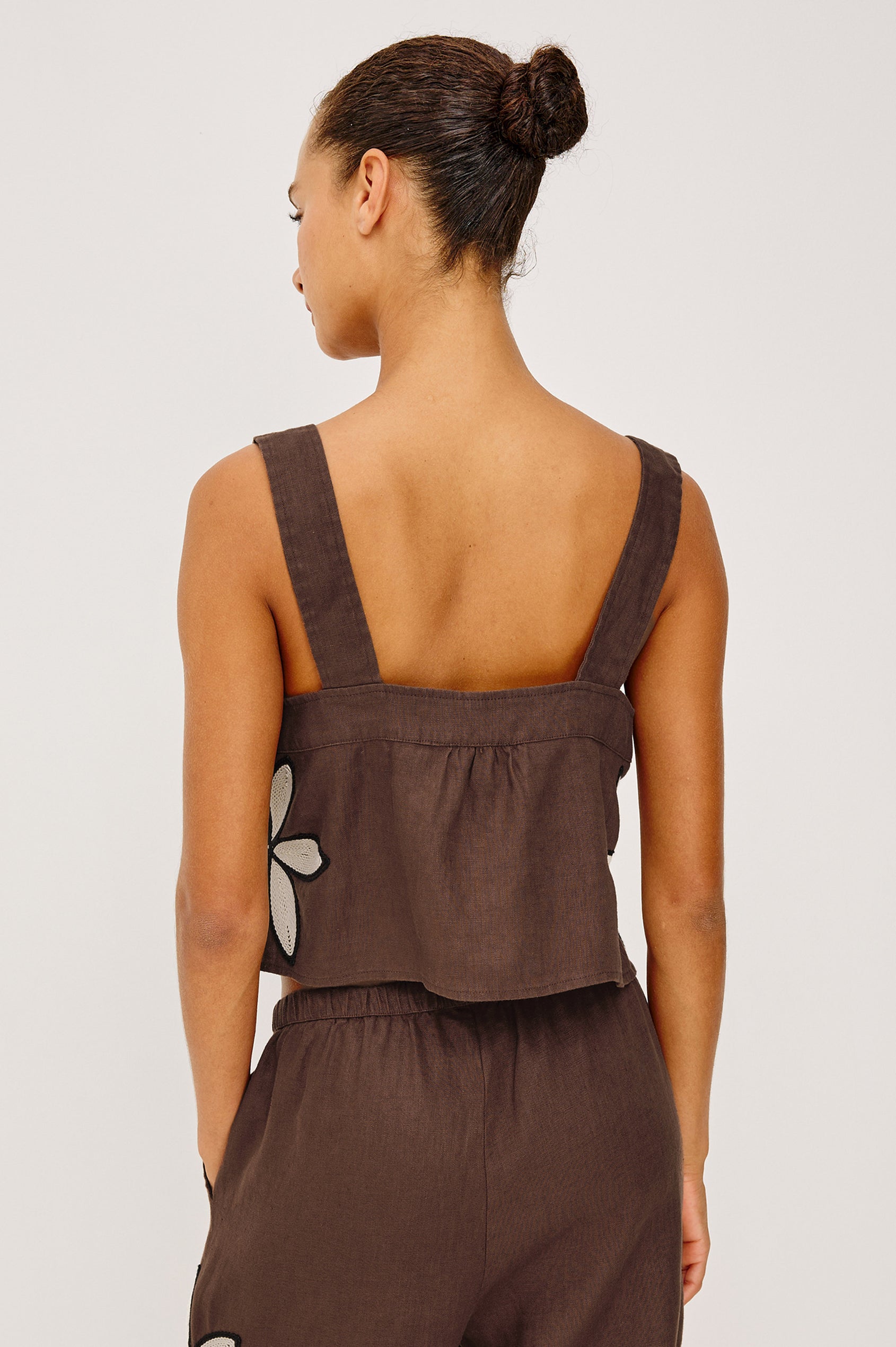 Calais Tank Top in Heavy Linen With Boxy, Loose Relaxed Cropped Fit, Wide Shoulder Straps, and V-Neckline With Adjustable Front Ties in Cocoa Floral Embroidery Colorway - Upper Body Back View Featured on Model