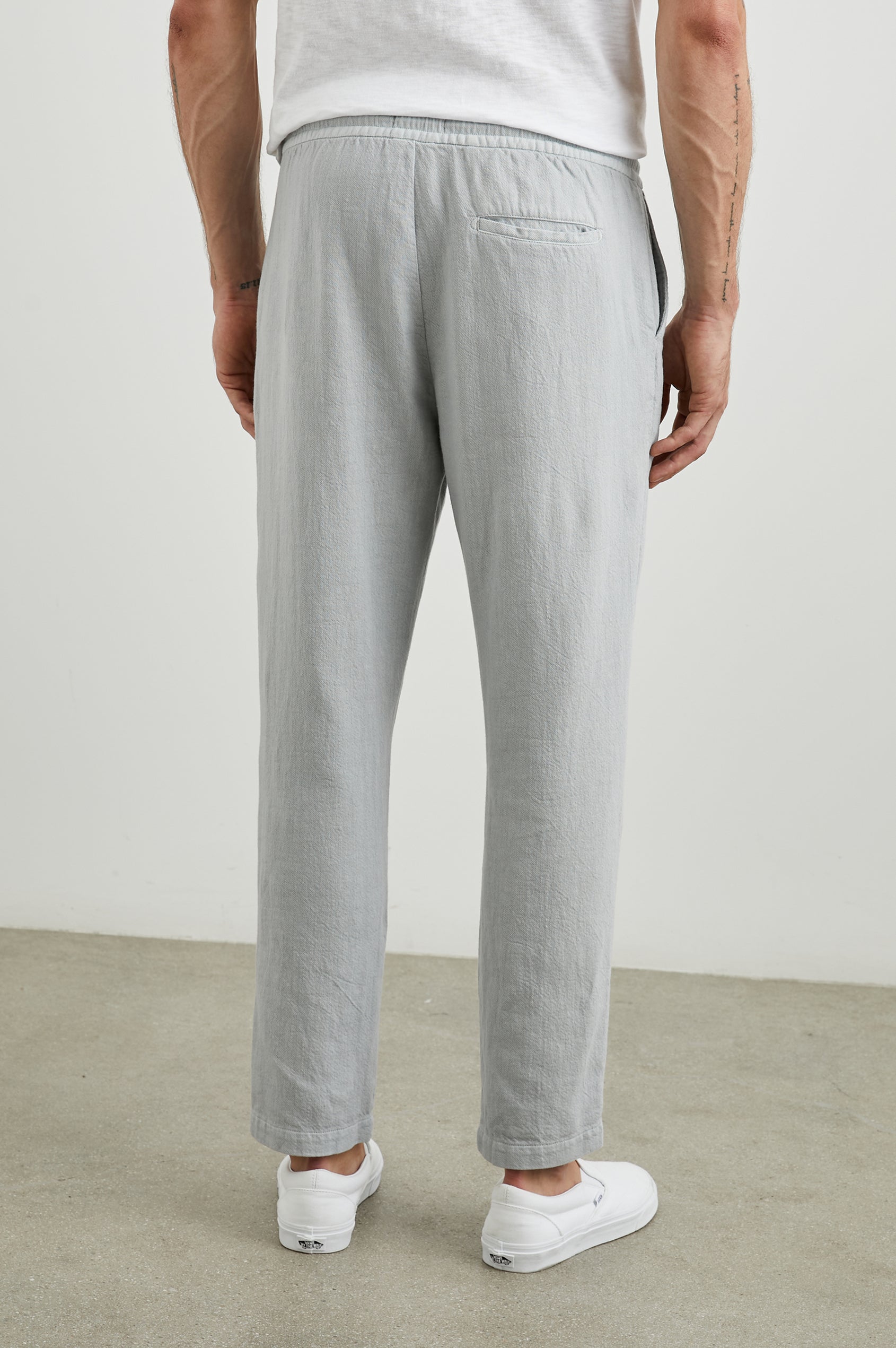 Callum Pants with a Drawstring Waist, Two Front Pockets and a Back Patch Pocket in Cement Colorway - Back View Featured on Model