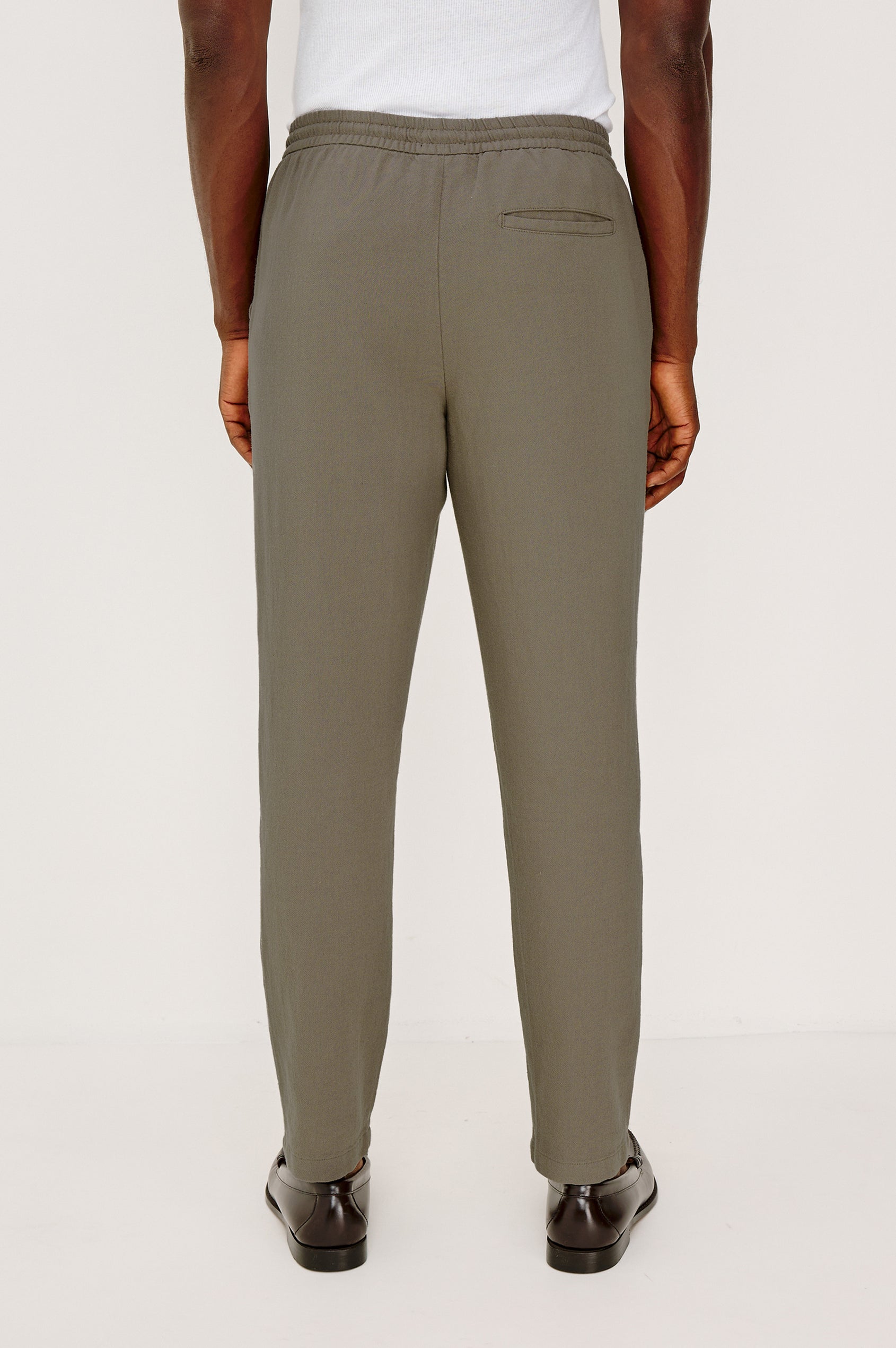 Callum Tapered Straight Leg Pant in Linen Twill With Adjustable Drawstring Waistband Ties in Fallen Rock Colorway - Lower Body Back View Featured on Model