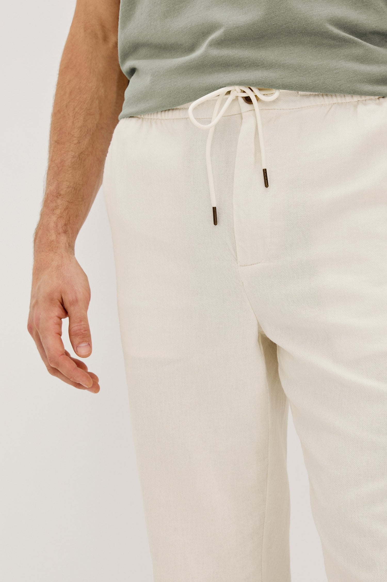 Callum extended length linen straight leg pant with elastic waistband and adjustable drawstring in Ecru - close up of details on model