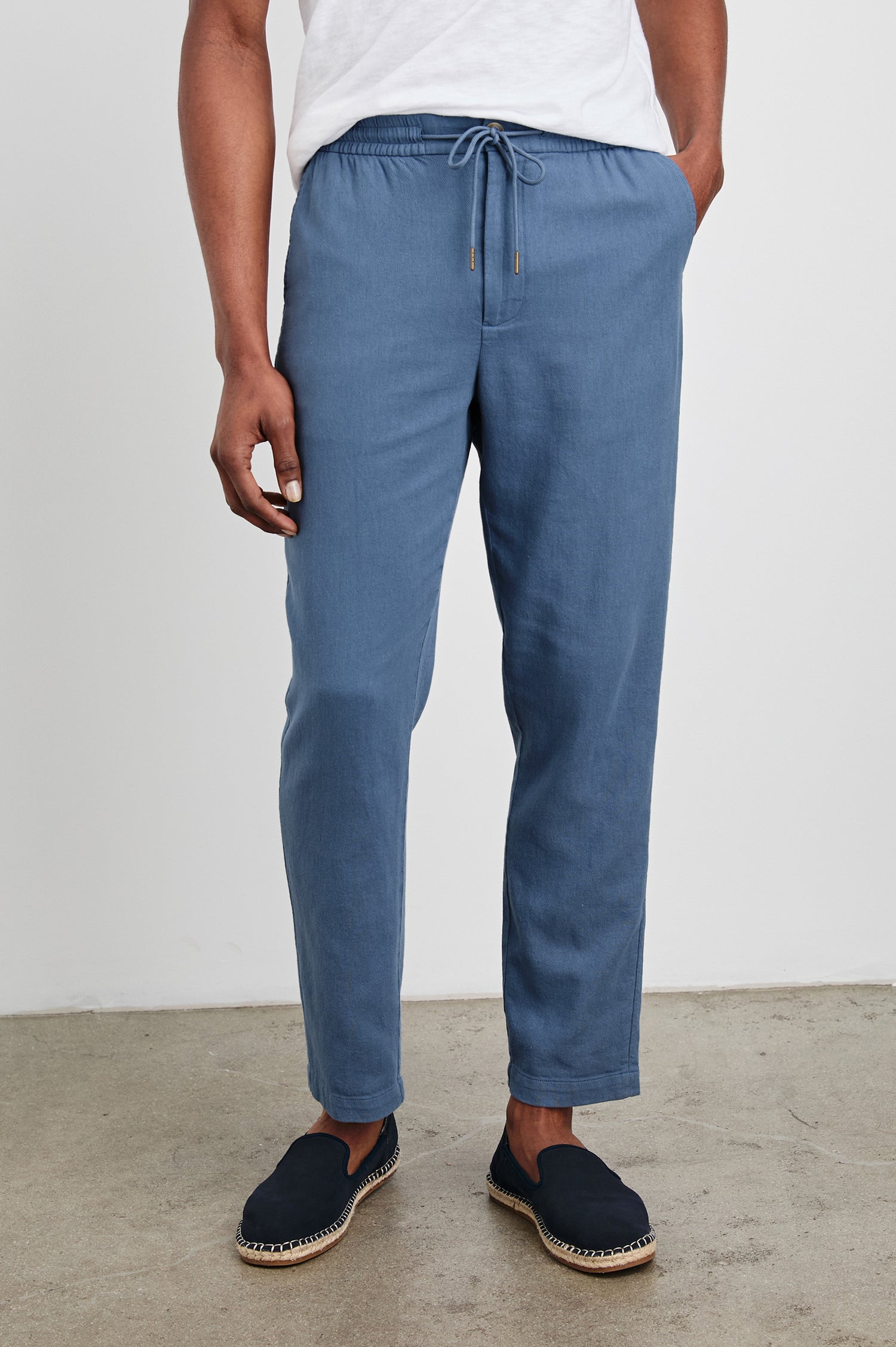 Callum Pants with a Drawstring Waist, Two Front Pockets and a Back Patch Pocket in Washed Blue Colorway - Front View Featured on Model.