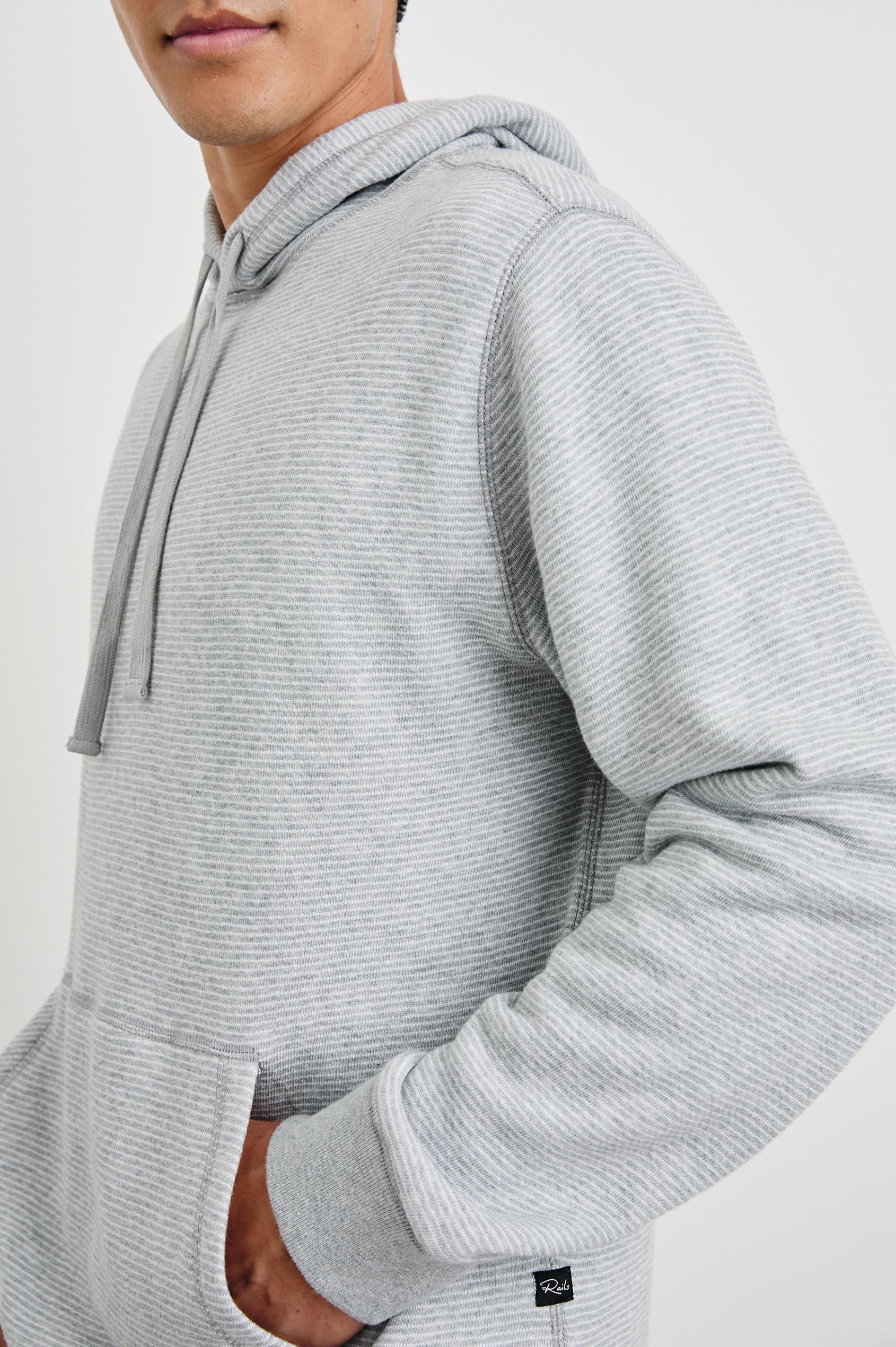 Calvin Long-Sleeve Hoodie with a Drawstring Hood and a Kangaroo Pocket in Heather Cream Stripe Colorway, Horizontal Stripes - Side View Featured on Model 