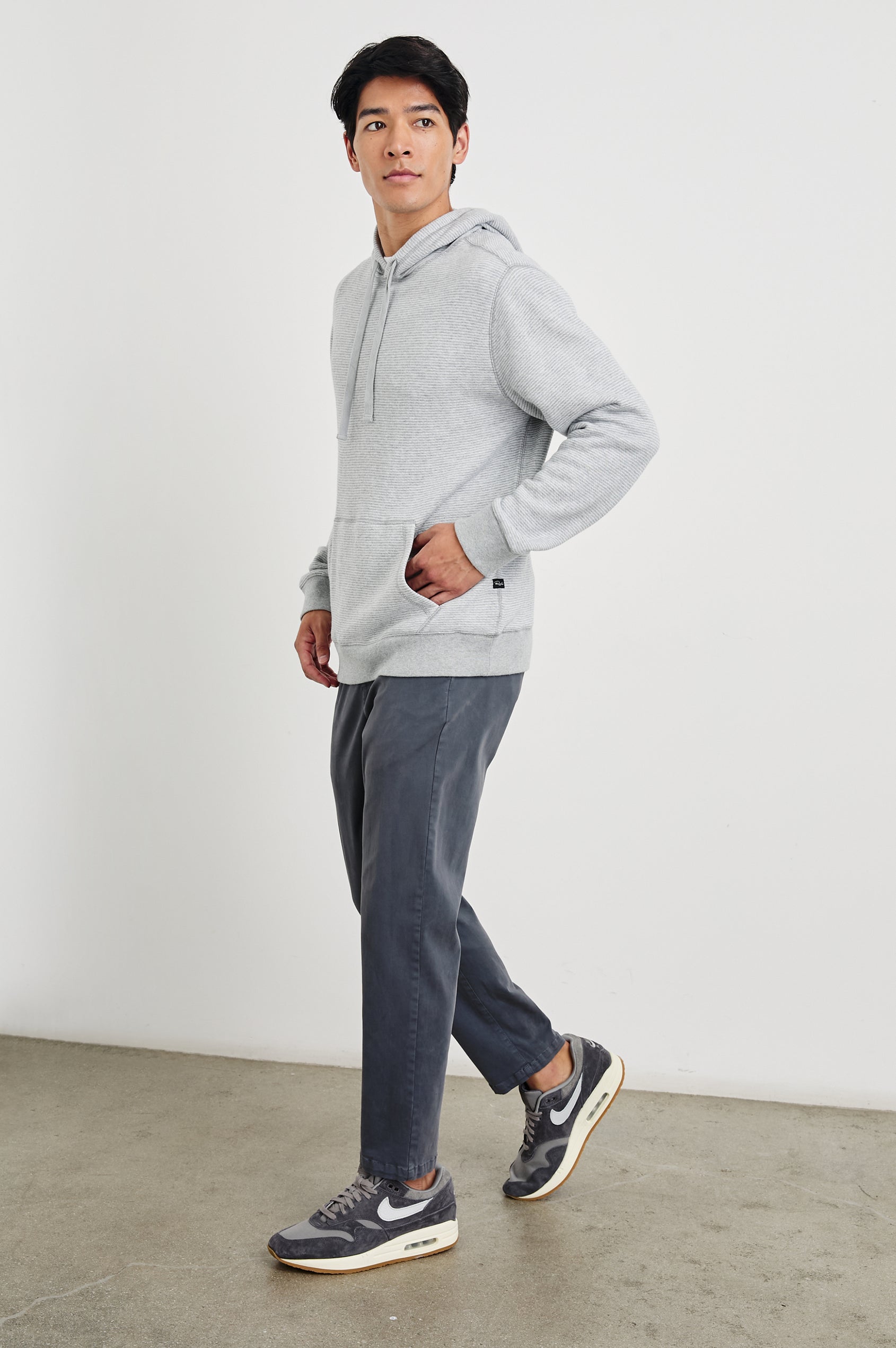 Calvin Long-Sleeve Hoodie with a Drawstring Hood and a Kangaroo Pocket in Heather Cream Stripe Colorway, Horizontal Stripes - Front Full Body View Featured on Model 