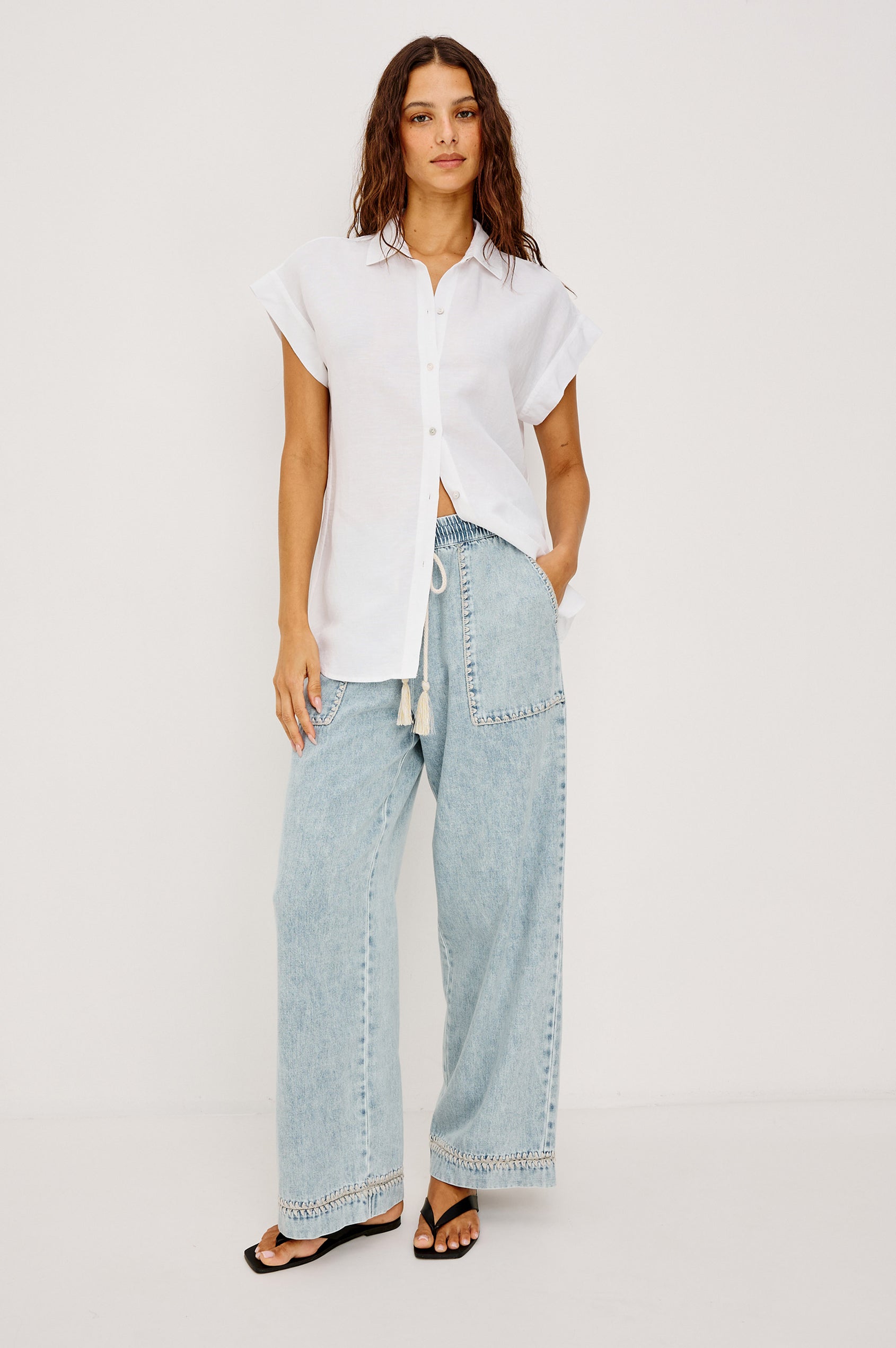 Campo Jean in Cotton Lyocell Denim With Blanket Stitching, Elastic Waist, Side Pockets, and Single Back Pocket in Indigo Blanket Stitch Colorway - Full Body Front View Featured on Model