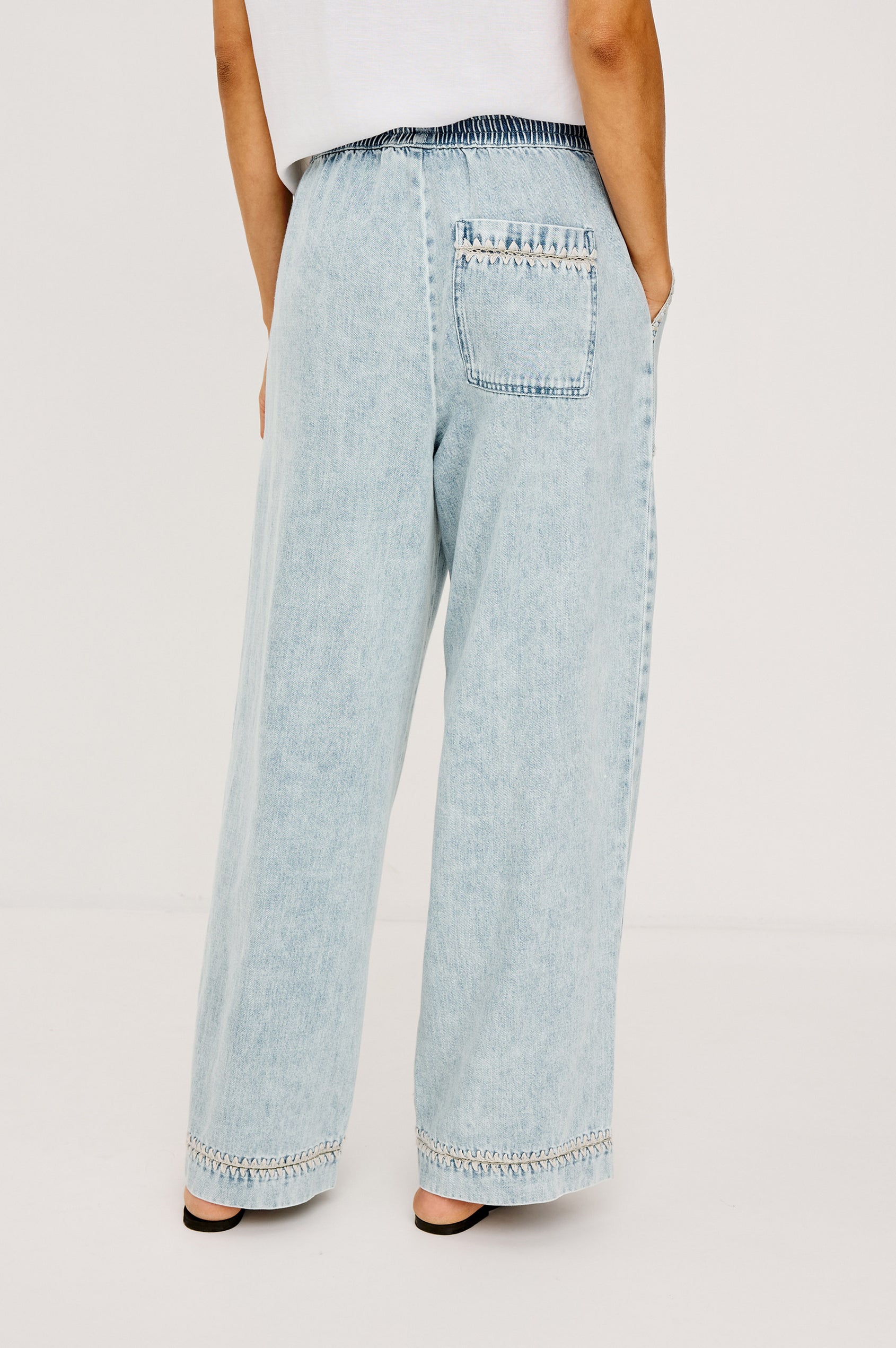 Campo Jean in Cotton Lyocell Denim With Blanket Stitching, Elastic Waist, Side Pockets, and Single Back Pocket in Indigo Blanket Stitch Colorway - Lower Body Back View Featured on Model