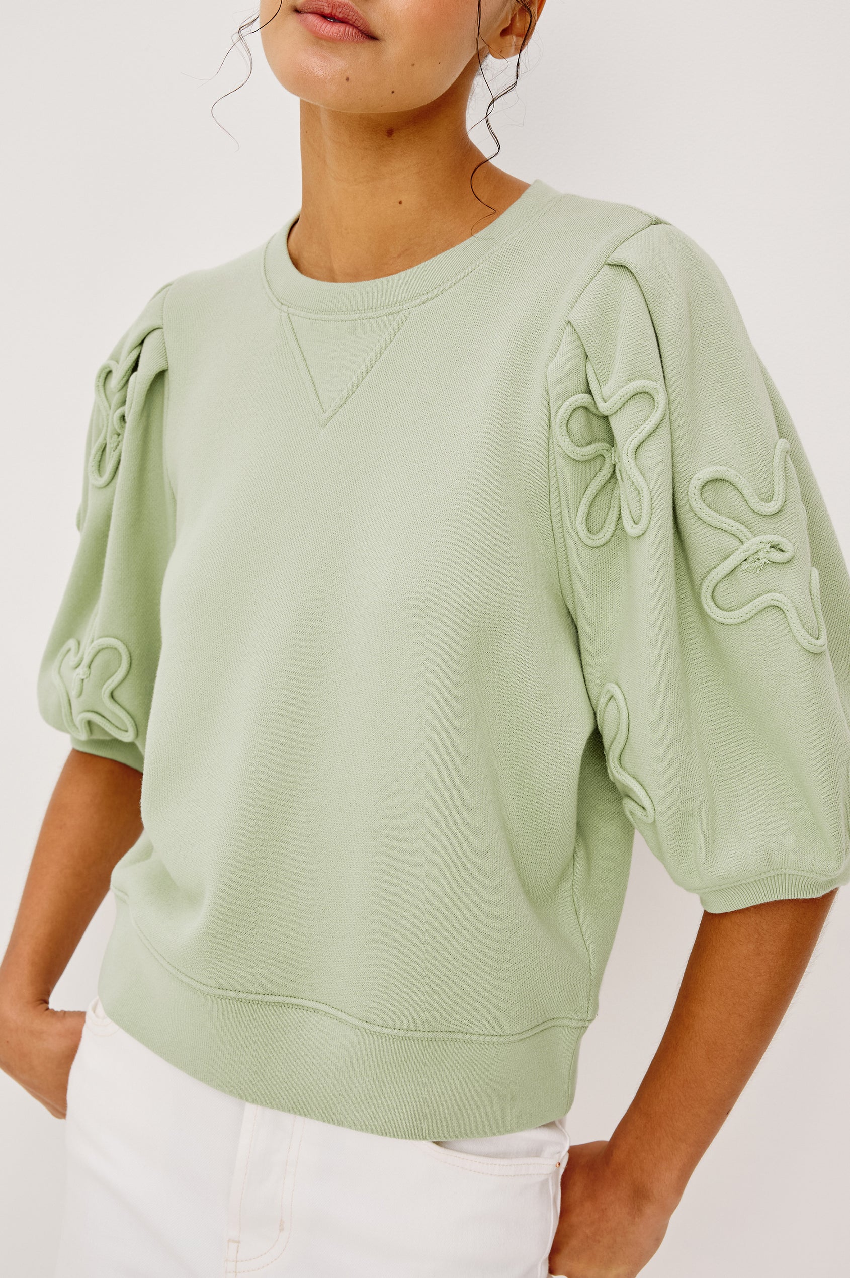 Camy Crewneck Sweatshirt in French Terry With Crew Neckline Soutached Florals and Puff Sleeves in Vintage Sage Colorway - Upper Body Close Up View Featured on Model