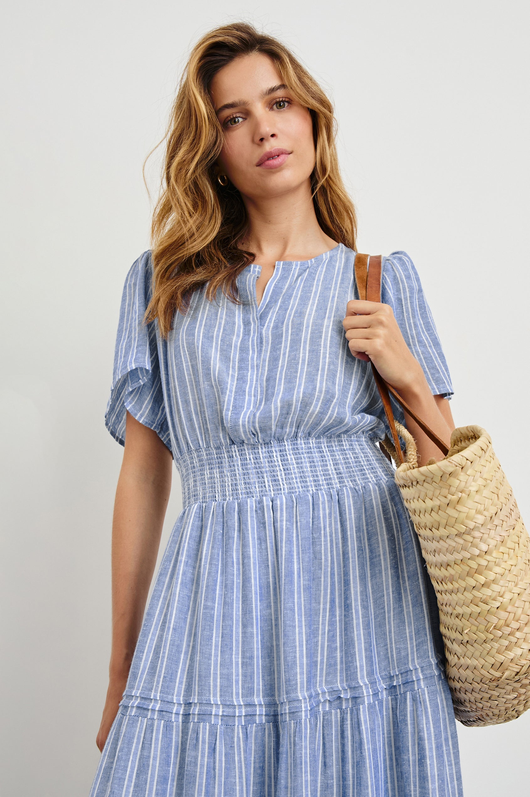 Cannes Short-Sleeve Midi Dress with a Shirred Waist, Tiered Skirt and Short Slit at Neck in Lake View Stripe Colorway, vertical stripes in blues and white - Front View Featured on Model