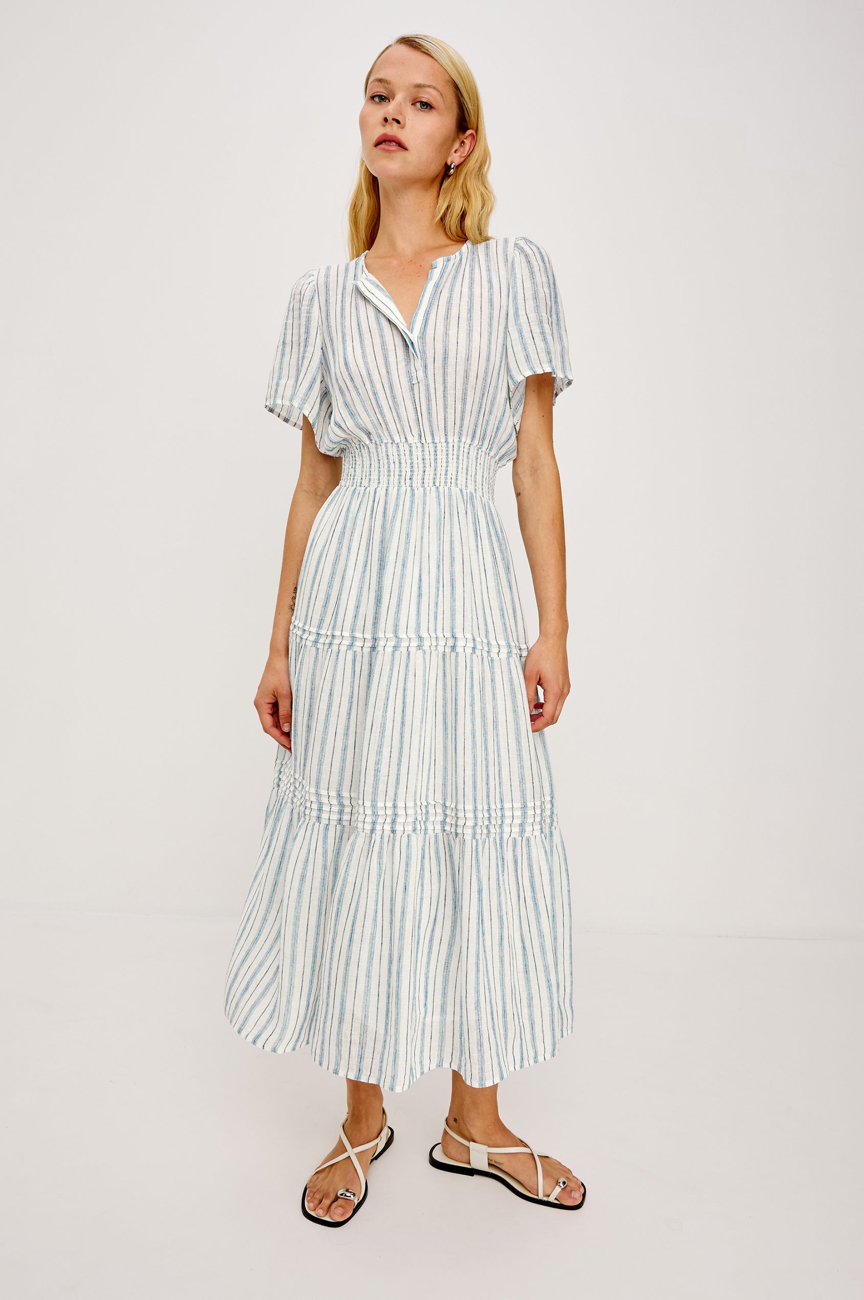 Cannes Midi in Linen With Half Placket Neckline Short Sleeves Smocked Waist and Tiered Skirt in Windward Stripe - Full Body Front View Featured on Model