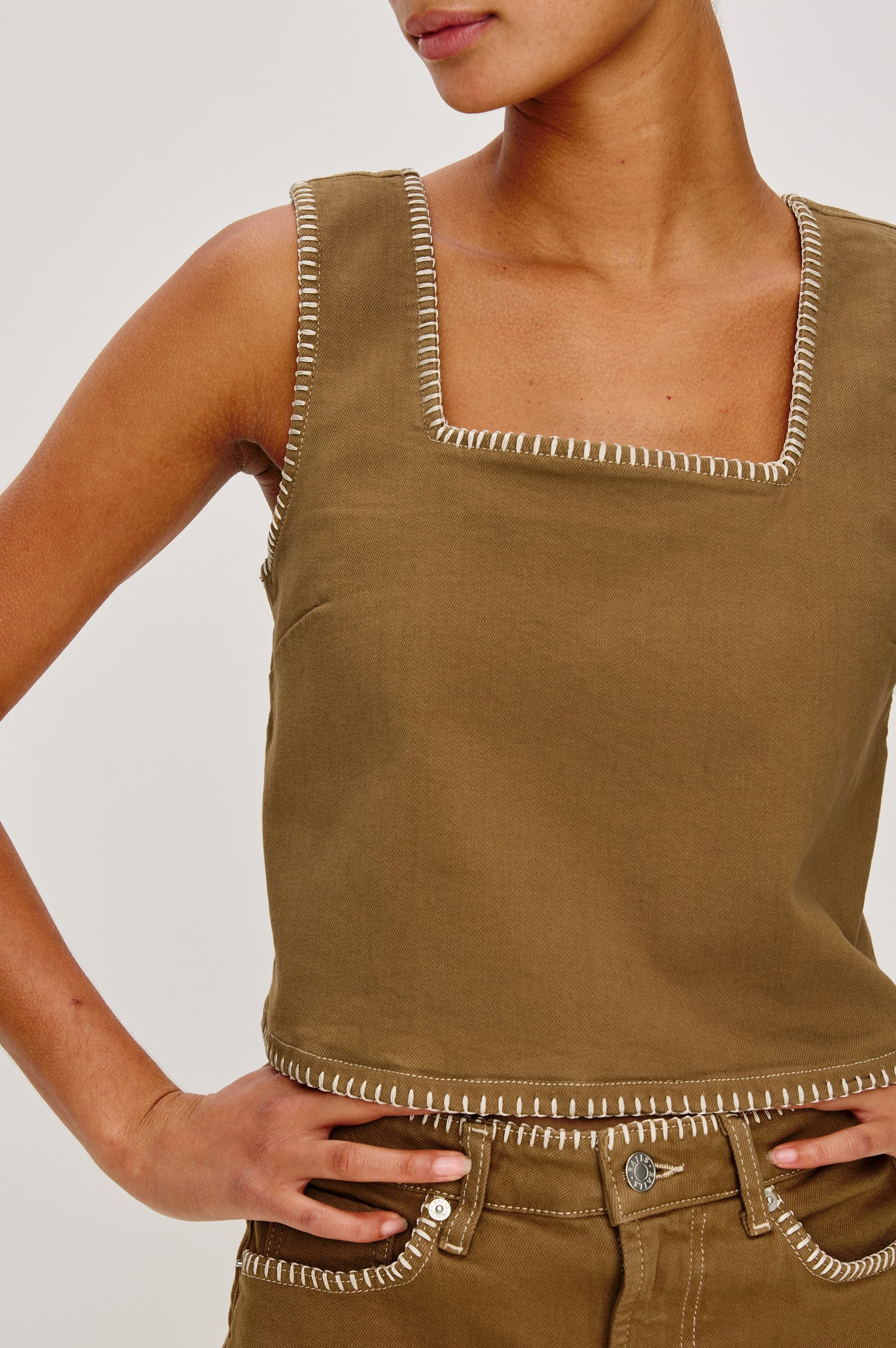 Carbon Denim Tank Top with Wide Straps, Square Neckline and Blanket Stitching on Edges in Safari Embroidered Colorway. Front Detail View on Model Shown.
