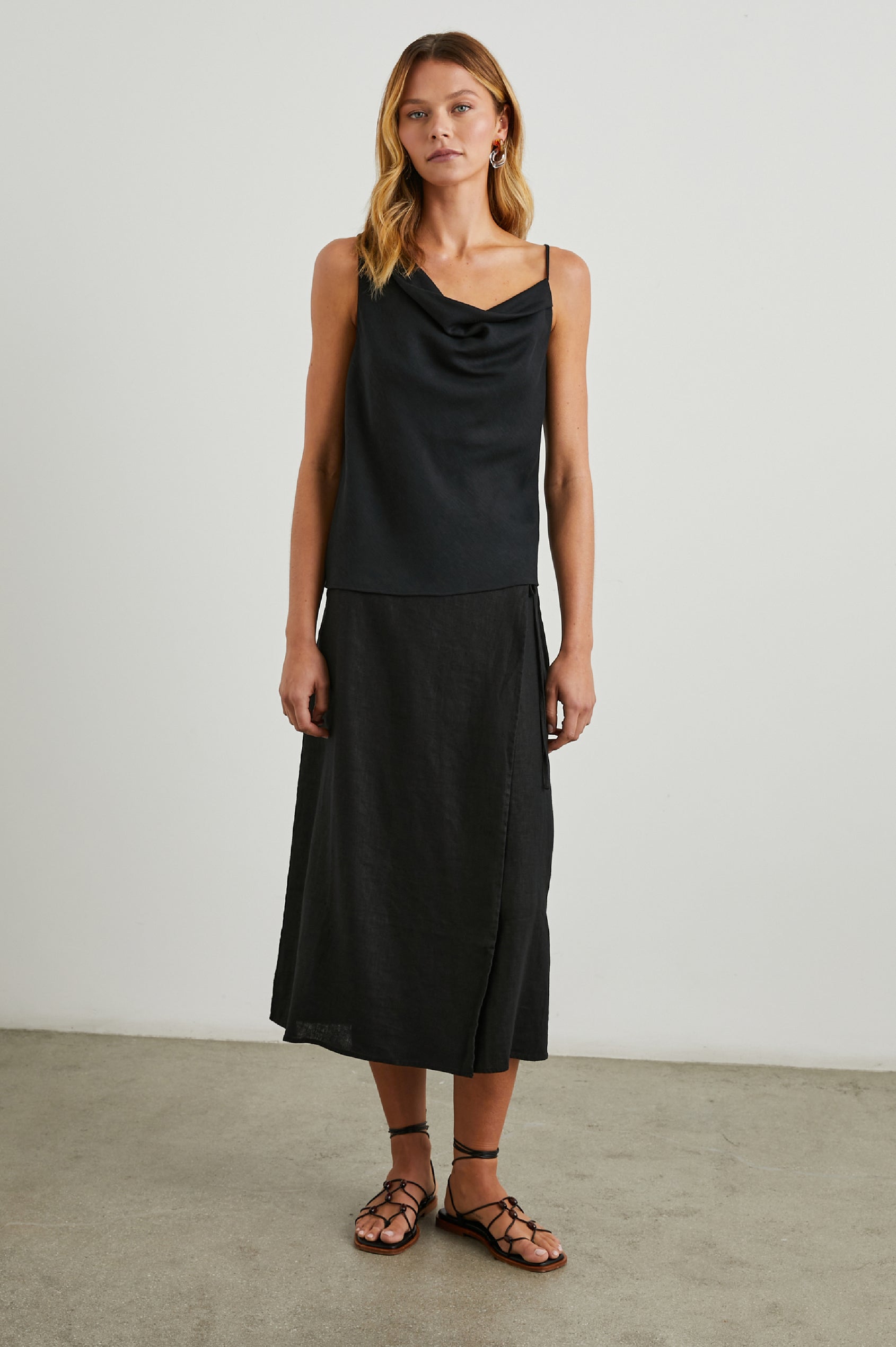 Carly Midi Wrap Skirt With a Side Tie in Black Colorway - Front Full Body View Featured on Model 