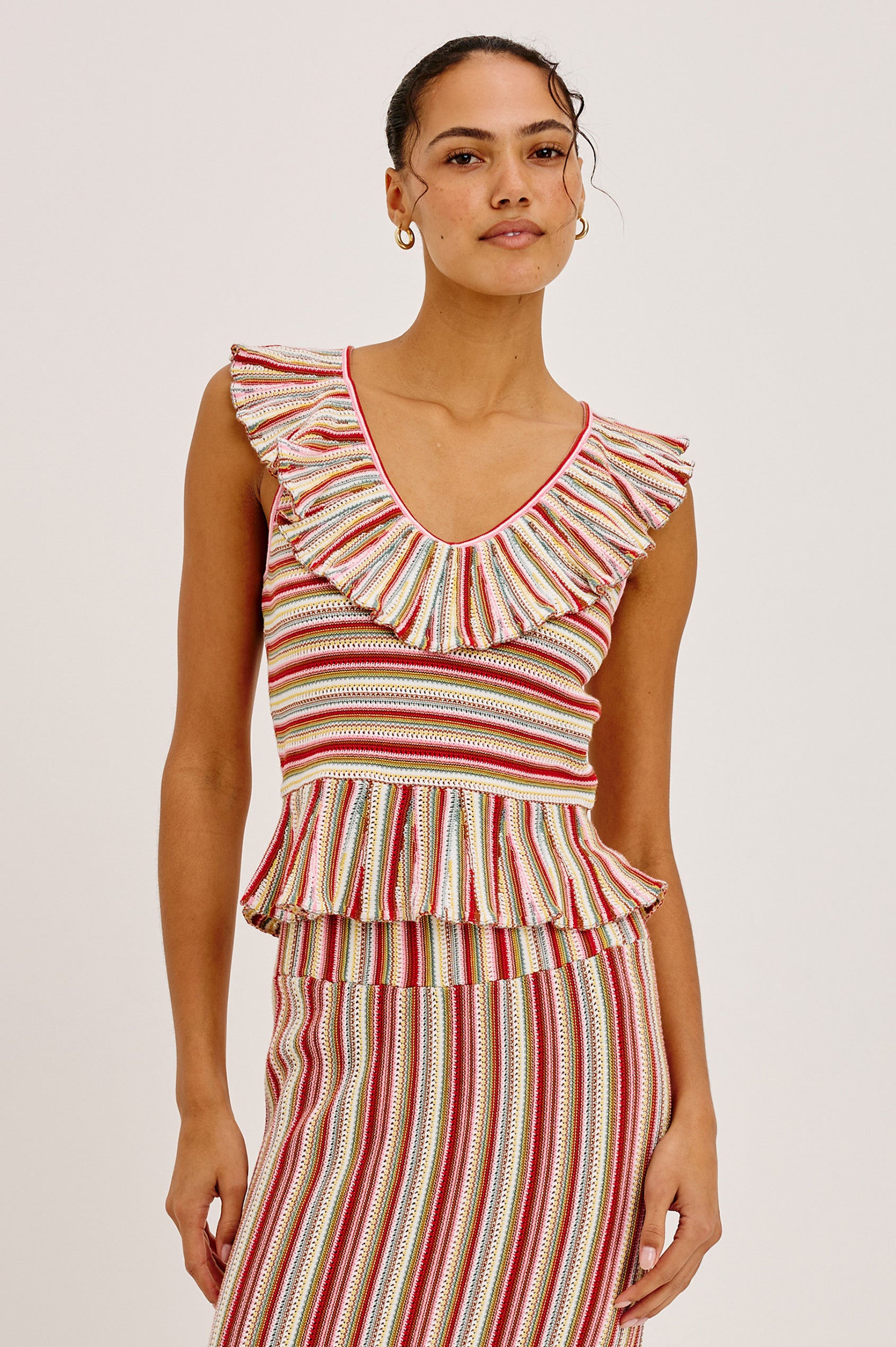 Carmelita Crop Top in Crochet Knit With Ruffle V-Neckline, Fitted Bodice, and Peplum Hem in Havana Stripe Colorway - Full Body Front View Featured on Model