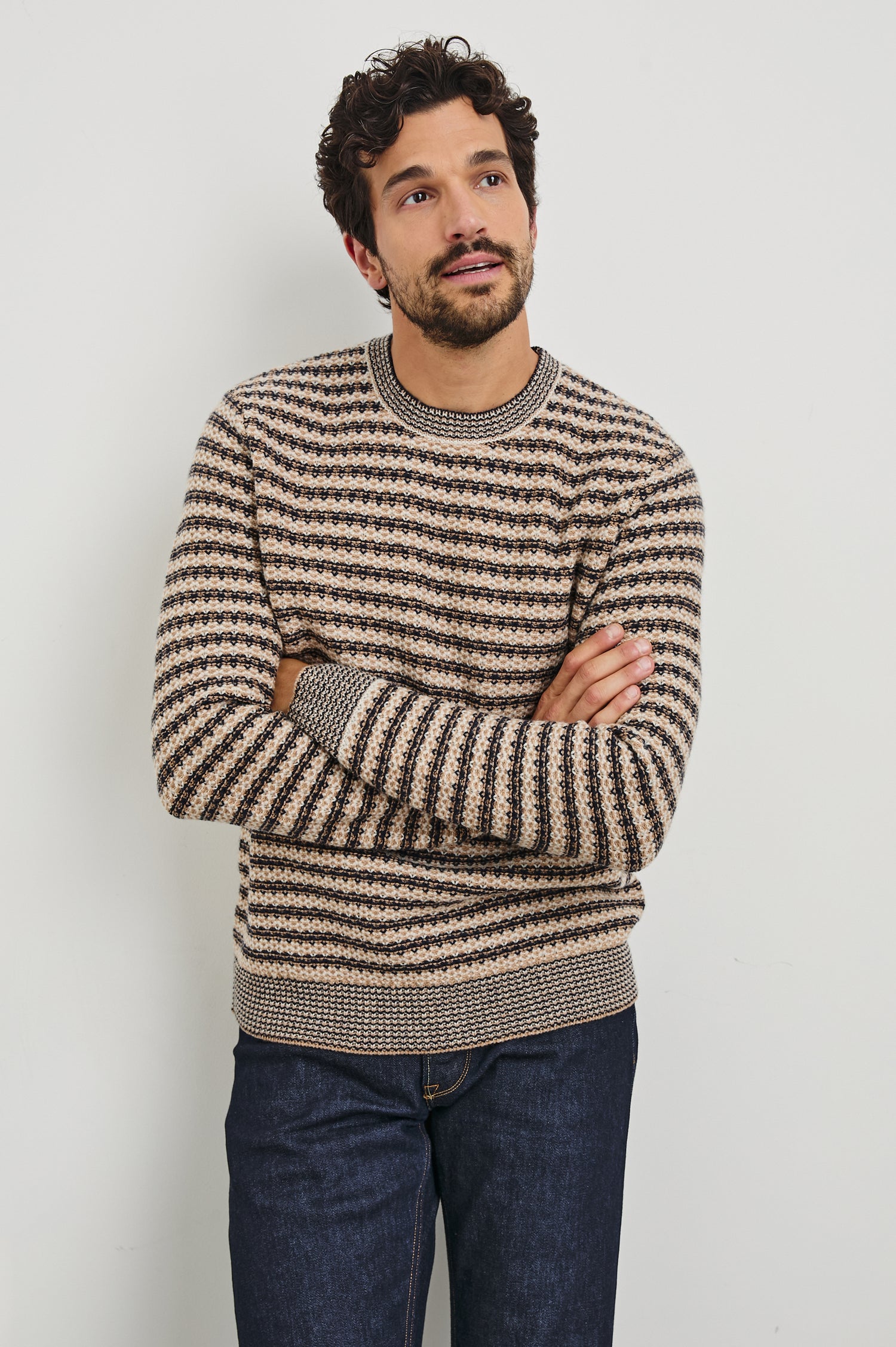 Men's Carrick long-sleeve crewneck sweater with horizontal navy and oat beige stripes. Front view of model featured.