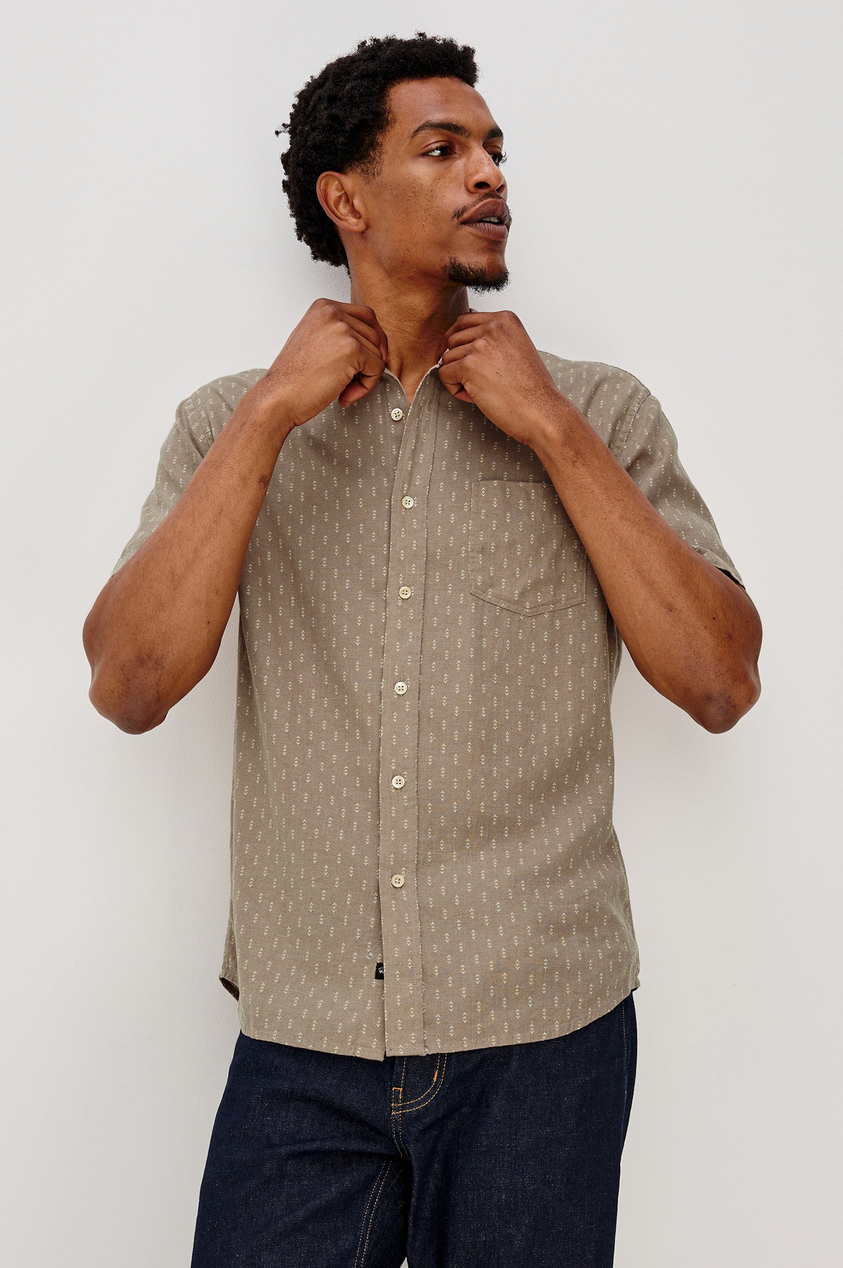 Carson button front collared shirt with short sleeves and a front patch pocket in Arrow Dot Crater colorway. Front View Shown on Model.