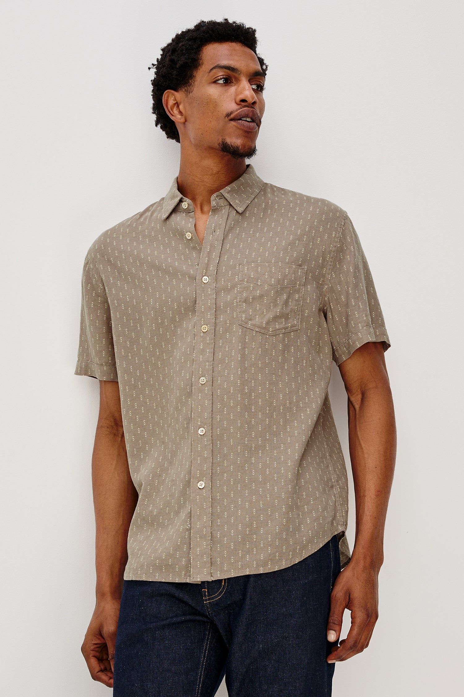Carson button front collared shirt with short sleeves and a front patch pocket in Arrow Dot Crater colorway. Front View Shown on Model.