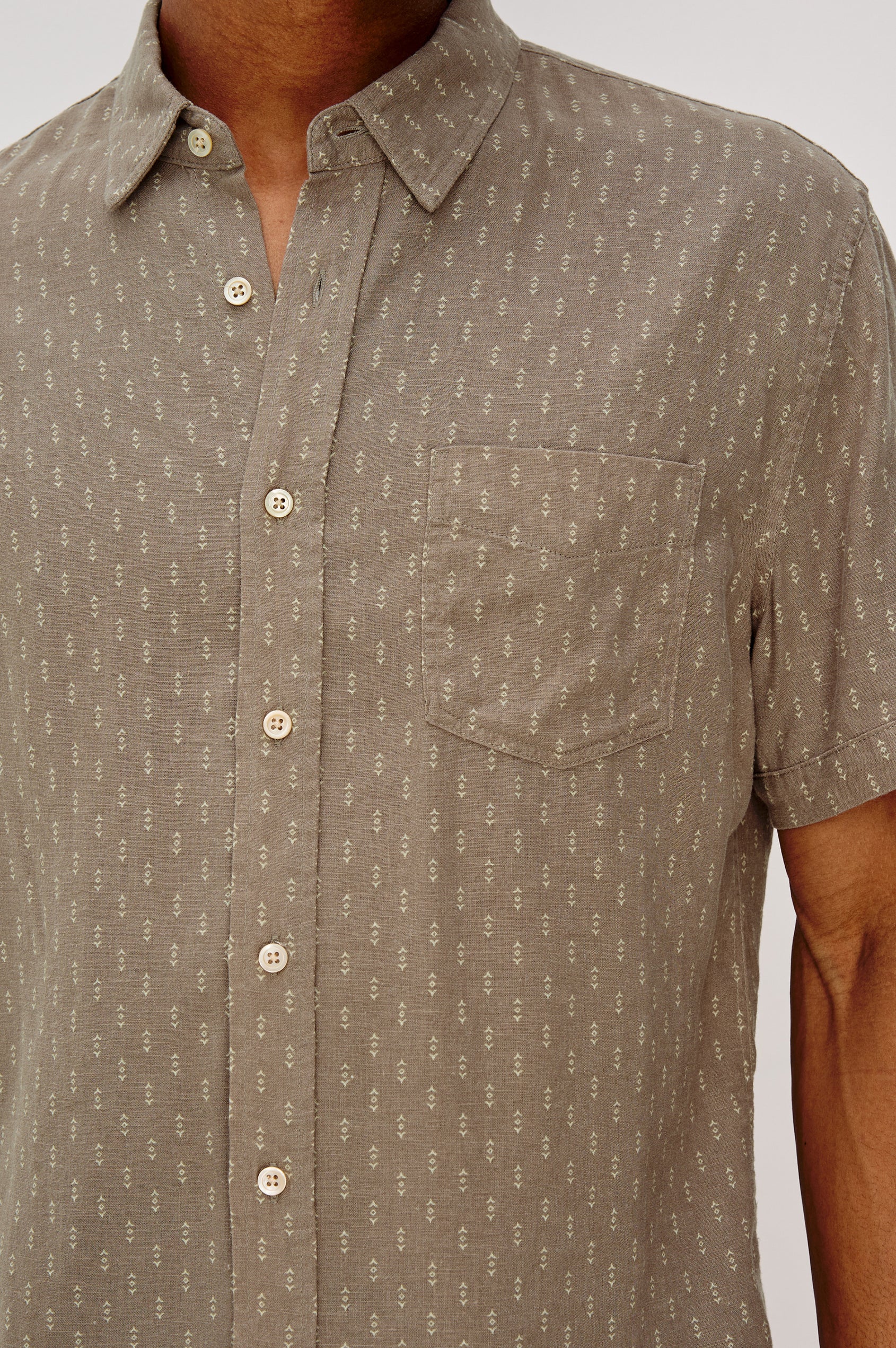 Carson button front collared shirt with short sleeves and a front patch pocket in Arrow Dot Crater colorway. Front Detail View Shown on Model.