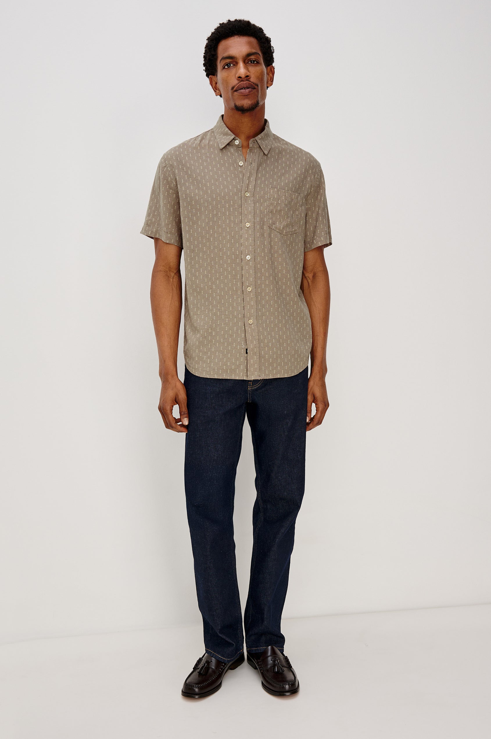 Carson button front collared shirt with short sleeves and a front patch pocket in Arrow Dot Crater colorway. Full Body Front View Shown on Model.