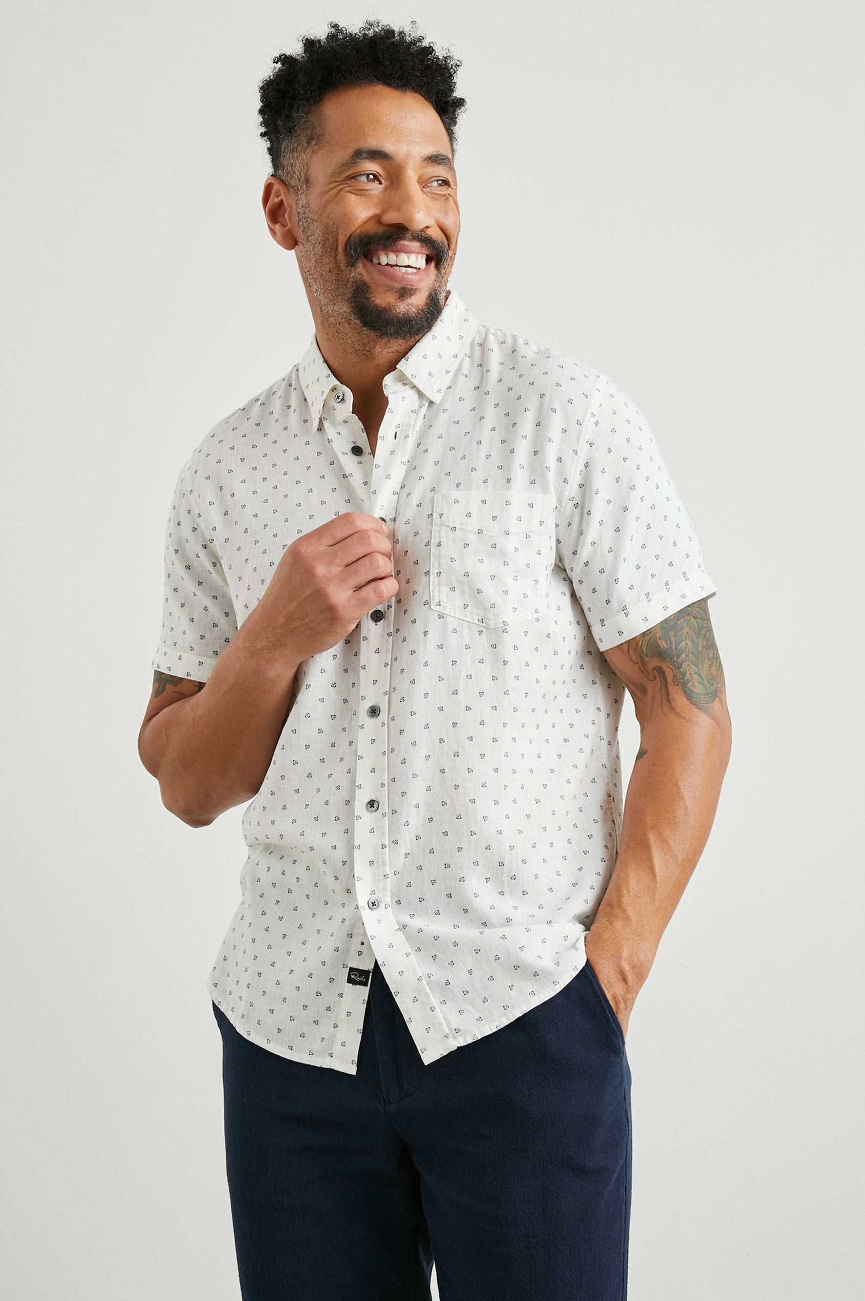 Carson Short Sleeve Button Up with a Chest Patch Pocket in Autumn Calico White Colorway, Small Blue Flowers on White- Front View Featured on Model