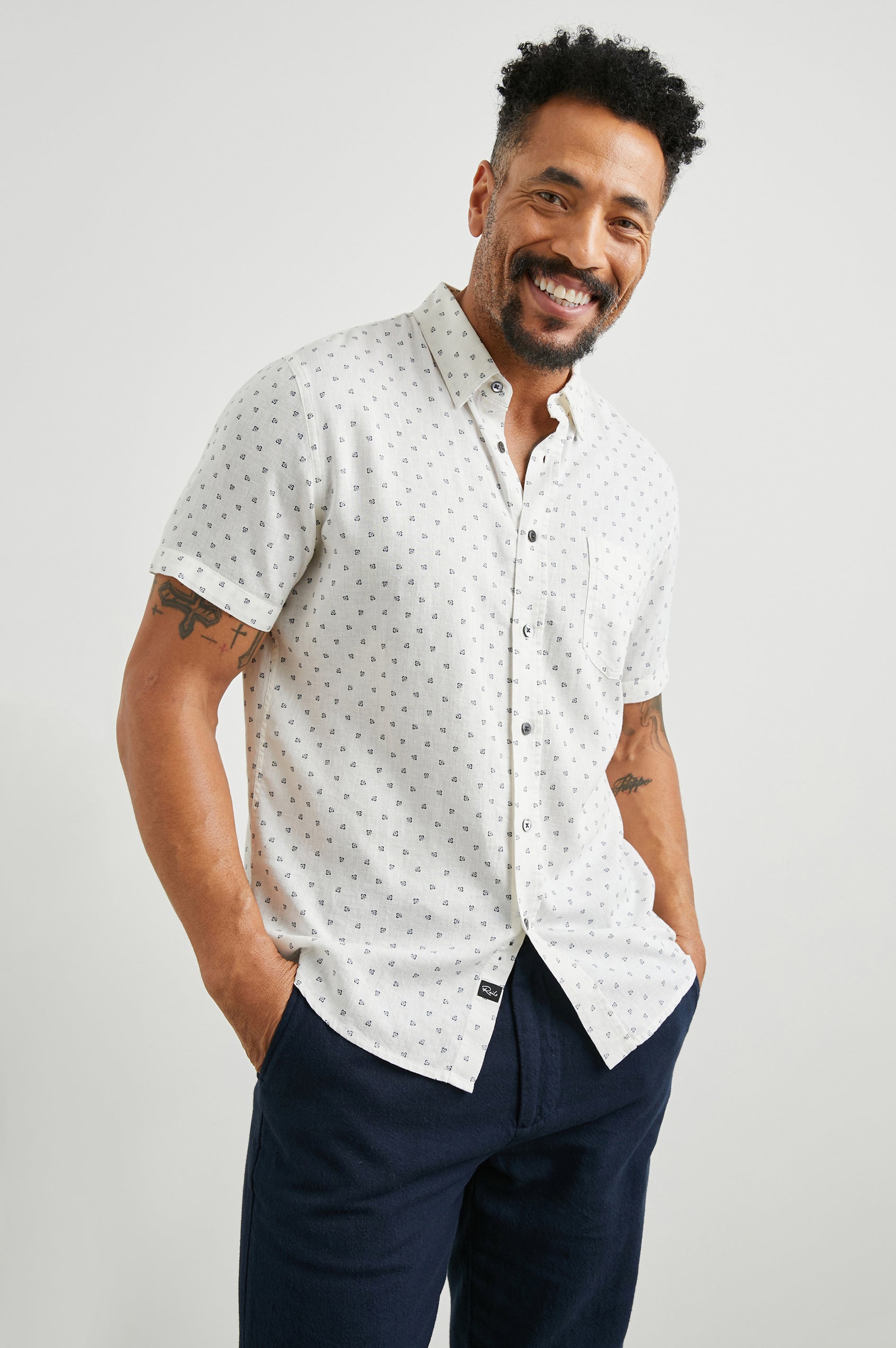 Carson Short Sleeve Button Up with a Chest Patch Pocket in Autumn Calico White Colorway, Small Blue Flowers on White- Front View Featured on Model