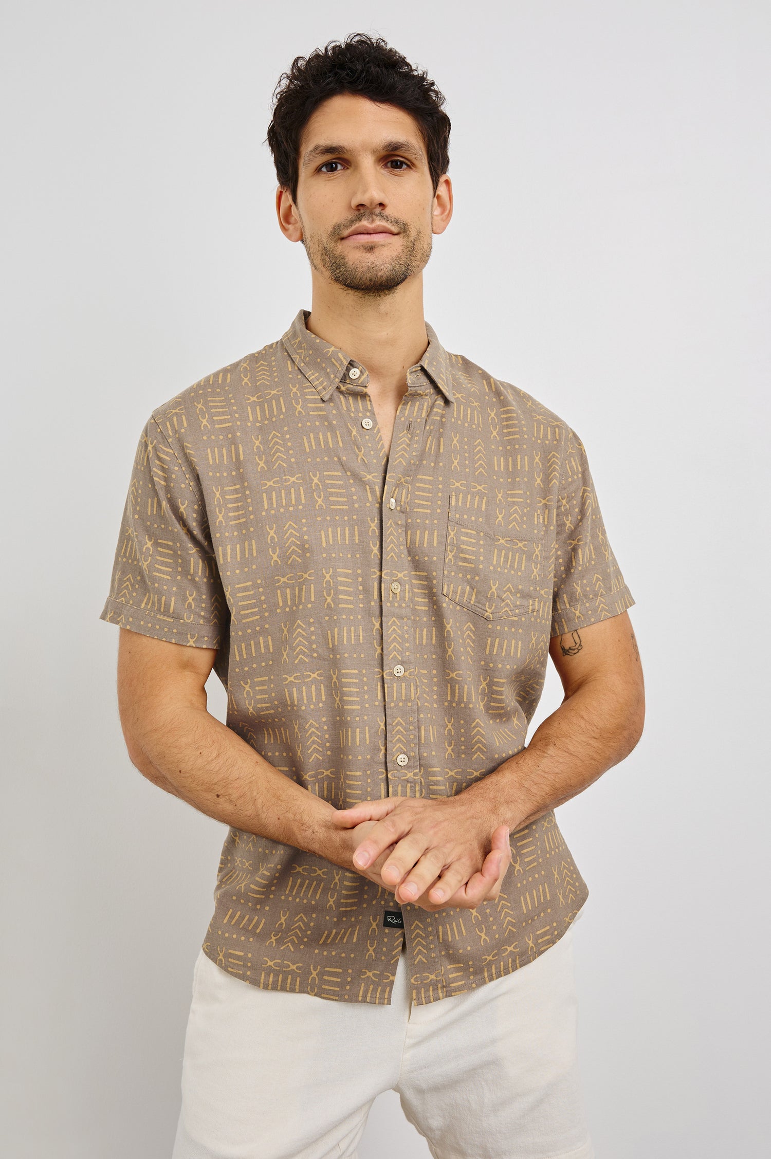 Carson Collared Button Front Shirt with Short Sleeves and a Chest Pocket in Bali Batik Brown Colorway. Front View Shown on Model.