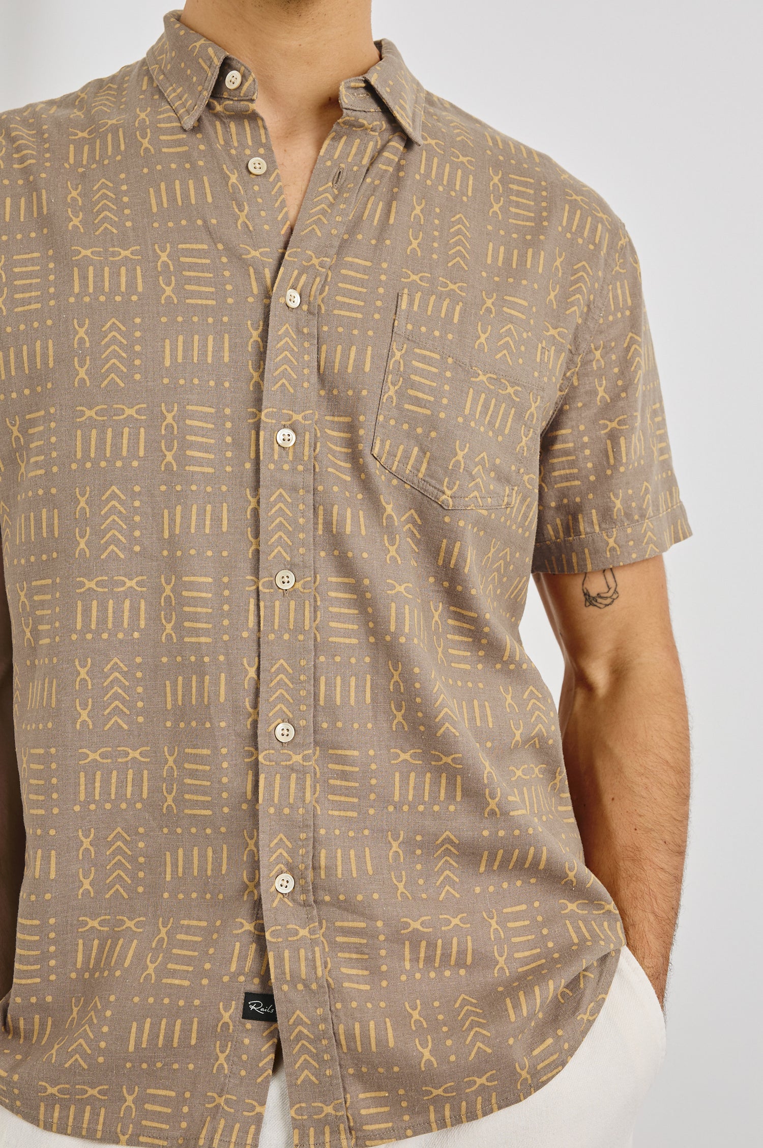 Carson Collared Button Front Shirt with Short Sleeves and a Chest Pocket in Bali Batik Brown Colorway. Front View Shown on Model.