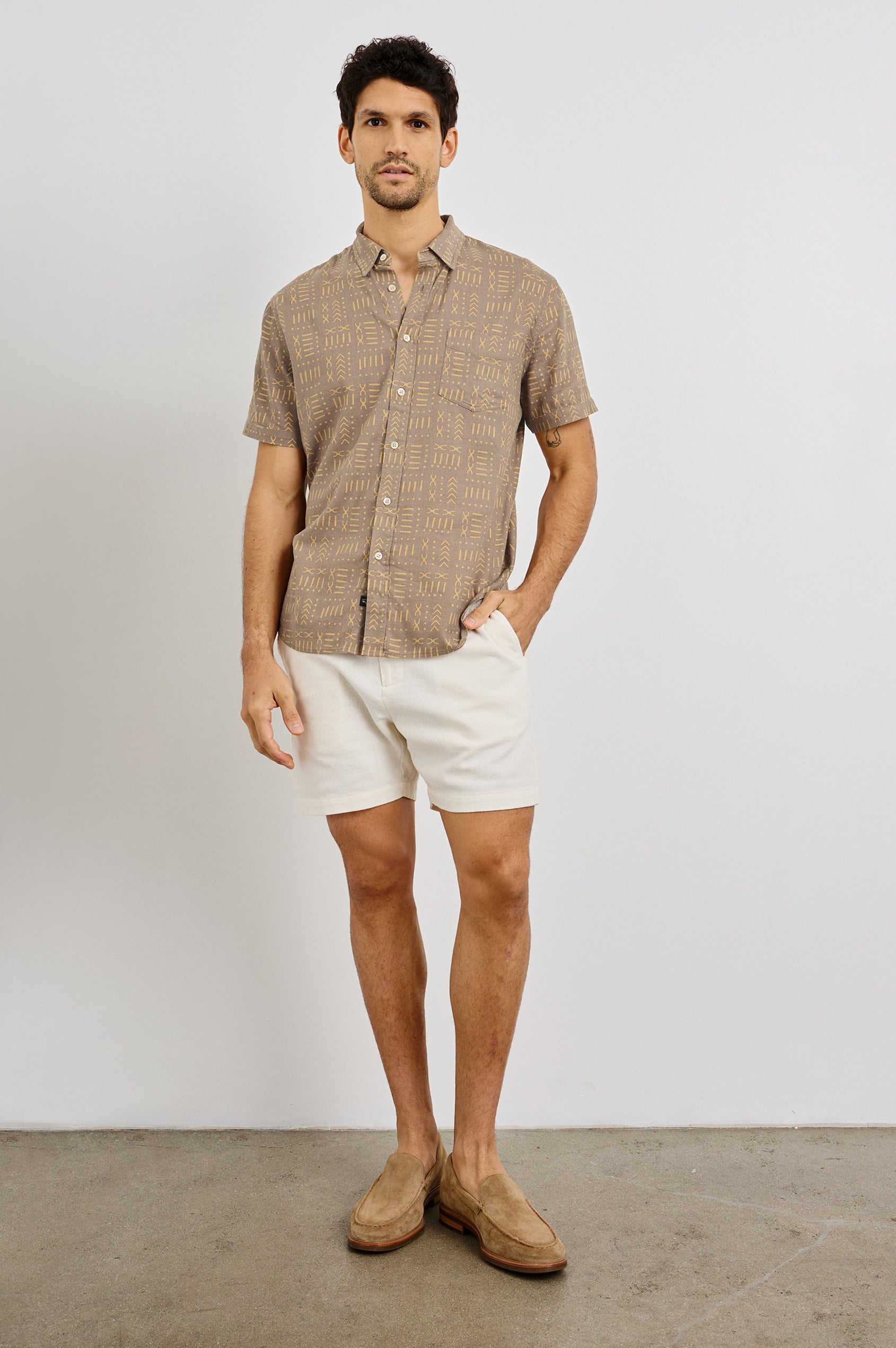 Carson Collared Button Front Shirt with Short Sleeves and a Chest Pocket in Bali Batik Brown Colorway. Front View Shown on Model.