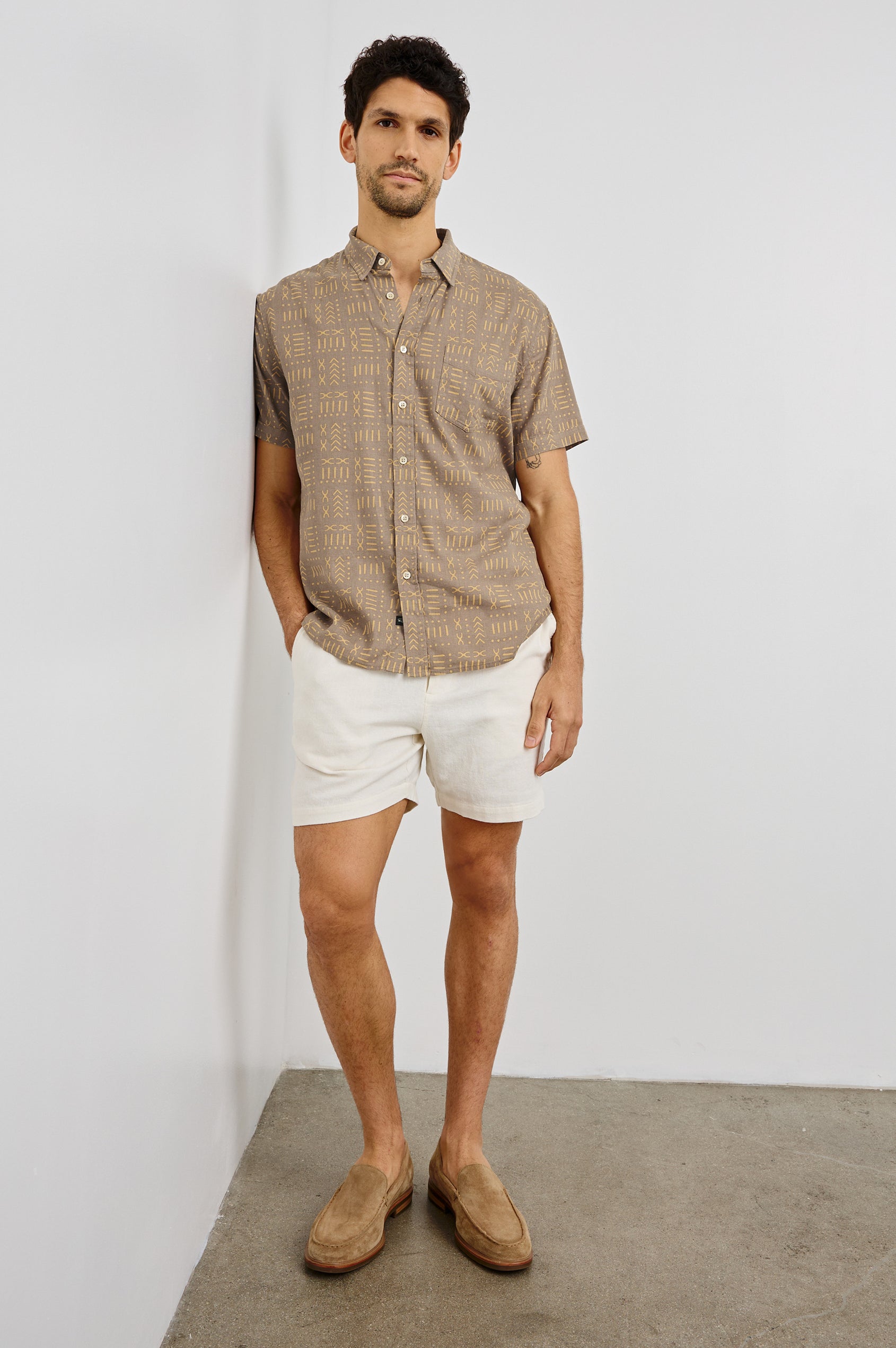 Carson Collared Button Front Shirt with Short Sleeves and a Chest Pocket in Bali Batik Brown Colorway. Front View Shown on Model.