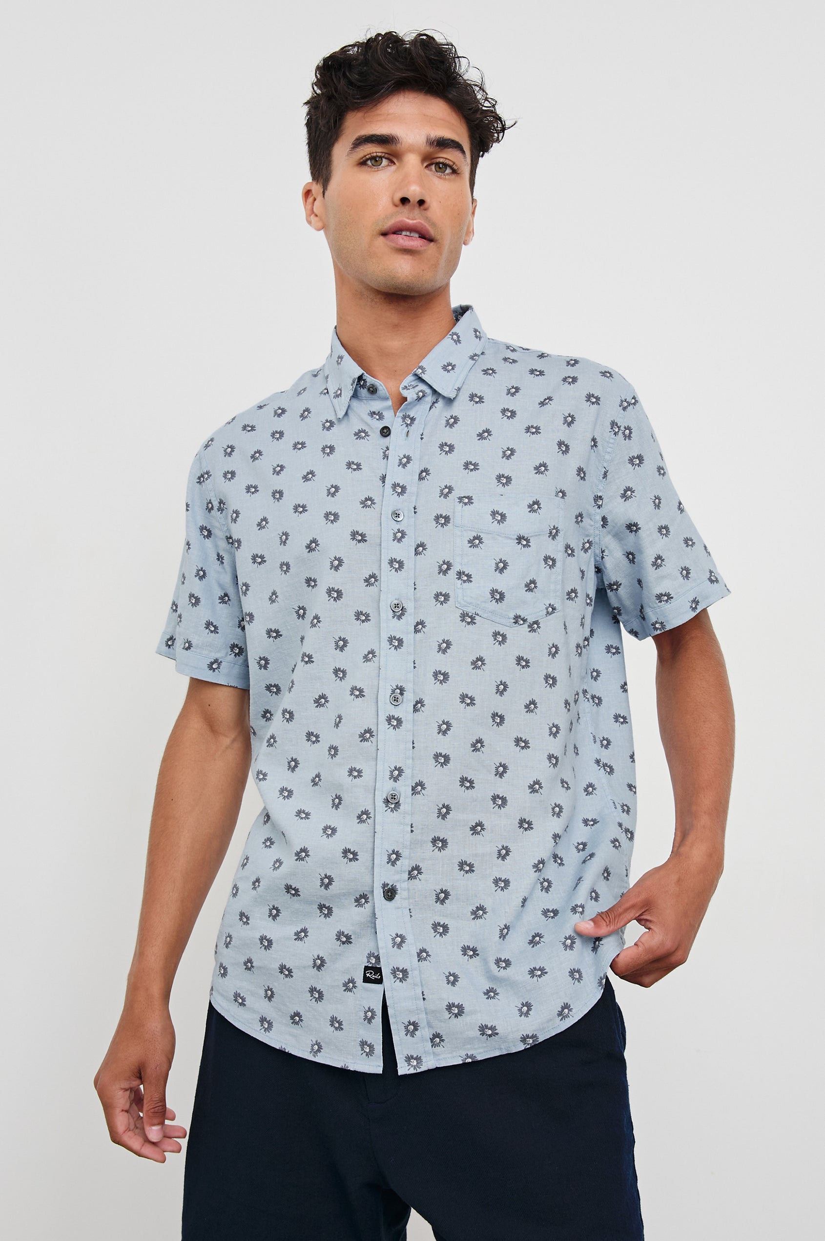 Carson linen short sleeve button down with a collar and floral pattern in Daisy Toss Celestial - front view on model