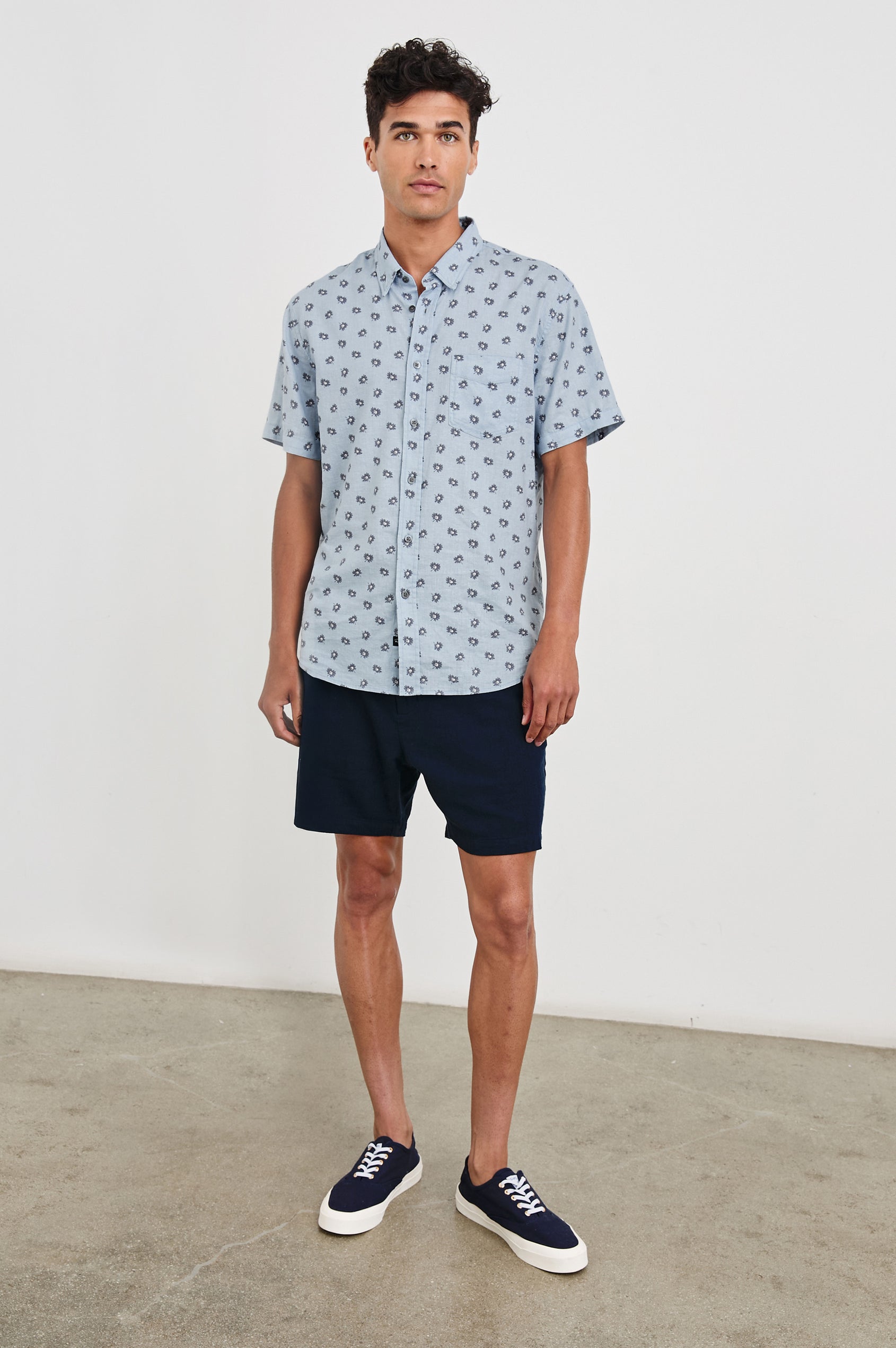 Carson linen short sleeve button down with a collar and floral pattern in Daisy Toss Celestial - full body front view on model
