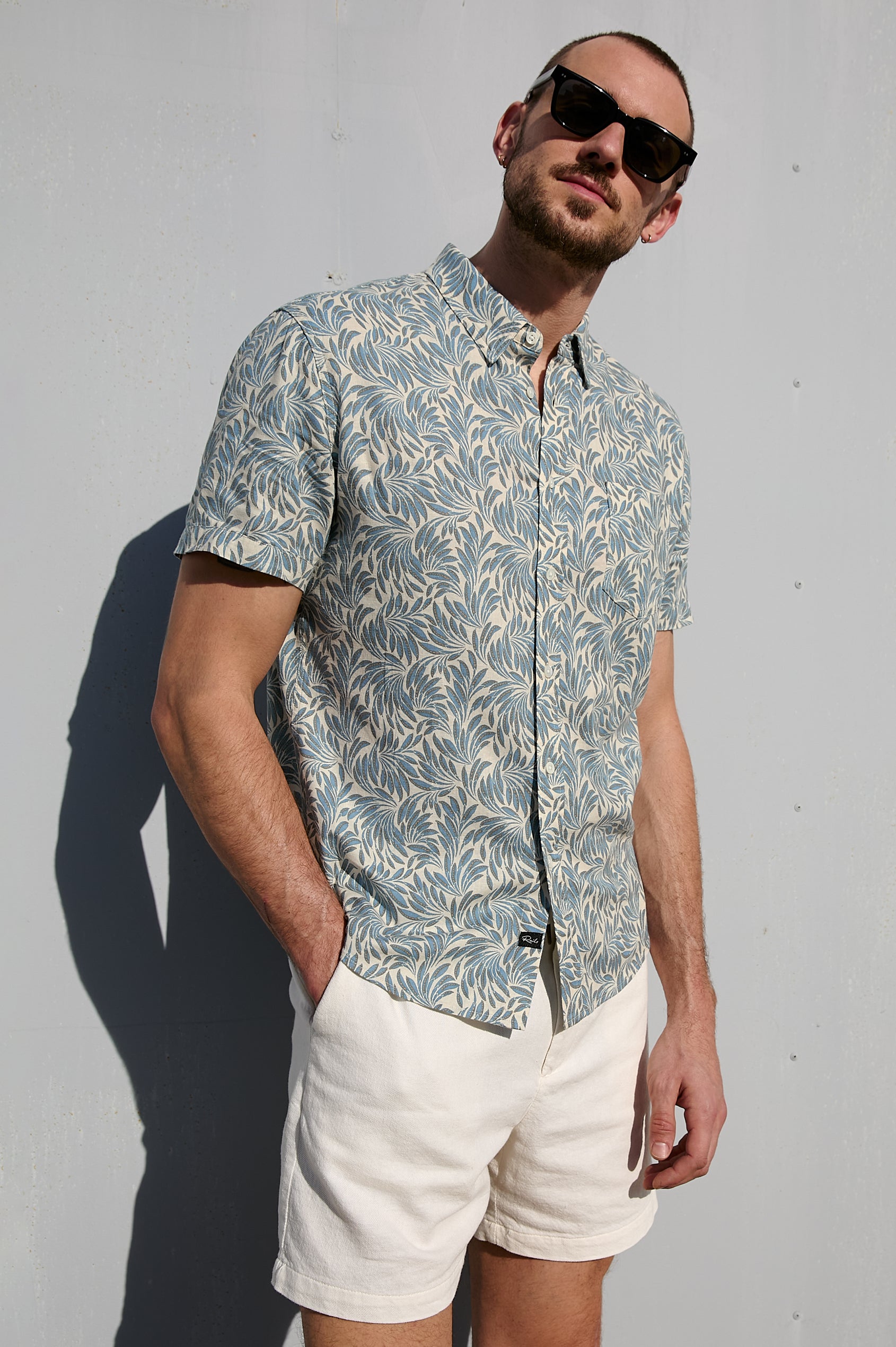 Carson Collared Button Front Shirt with Short Sleeves and a Chest Pocket in Ecru Banana Leaf Colorway. Front View Shown on Model.