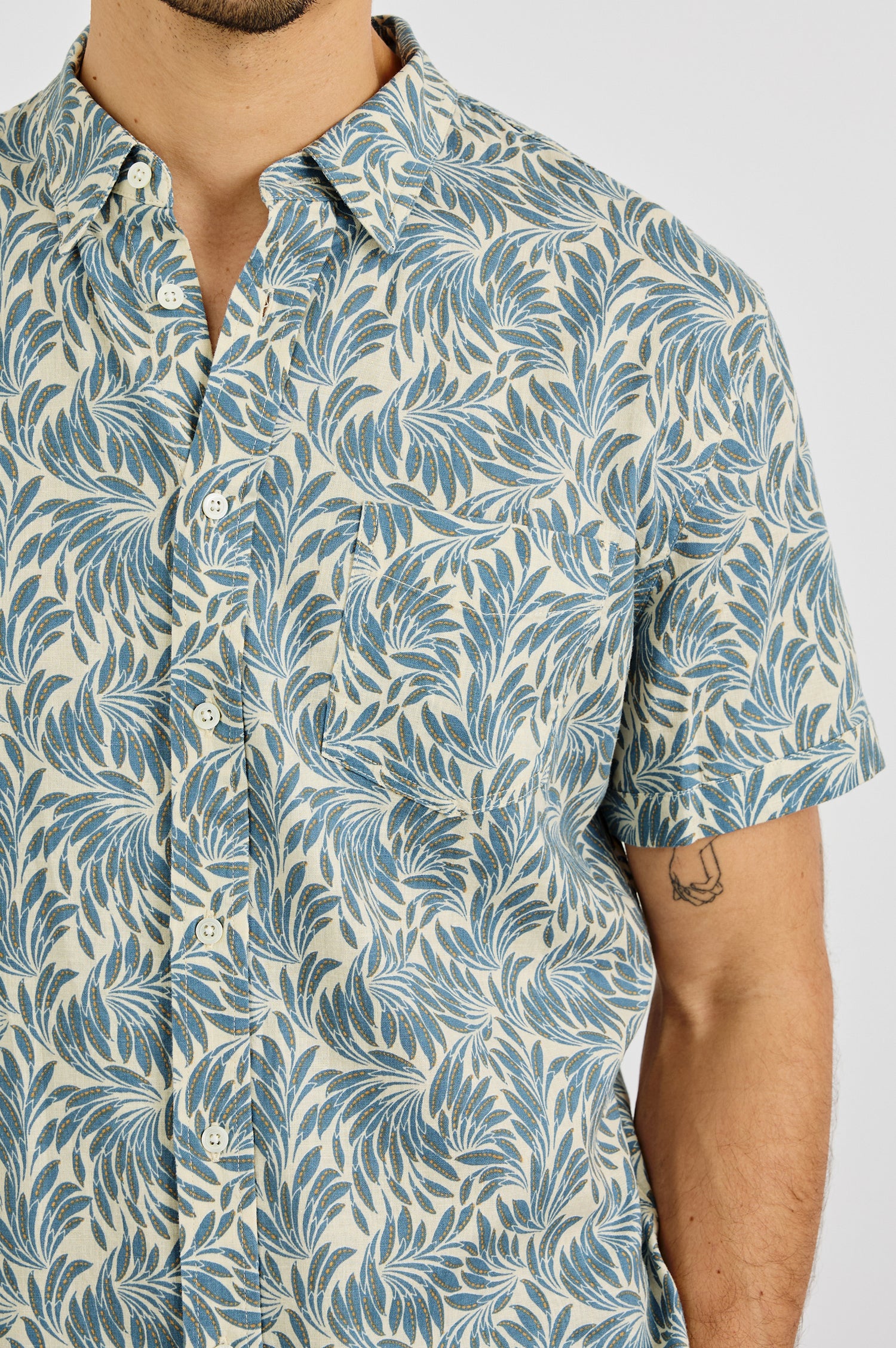 Carson Collared Button Front Shirt with Short Sleeves and a Chest Pocket in Ecru Banana Leaf Colorway. Front View Shown on Model.