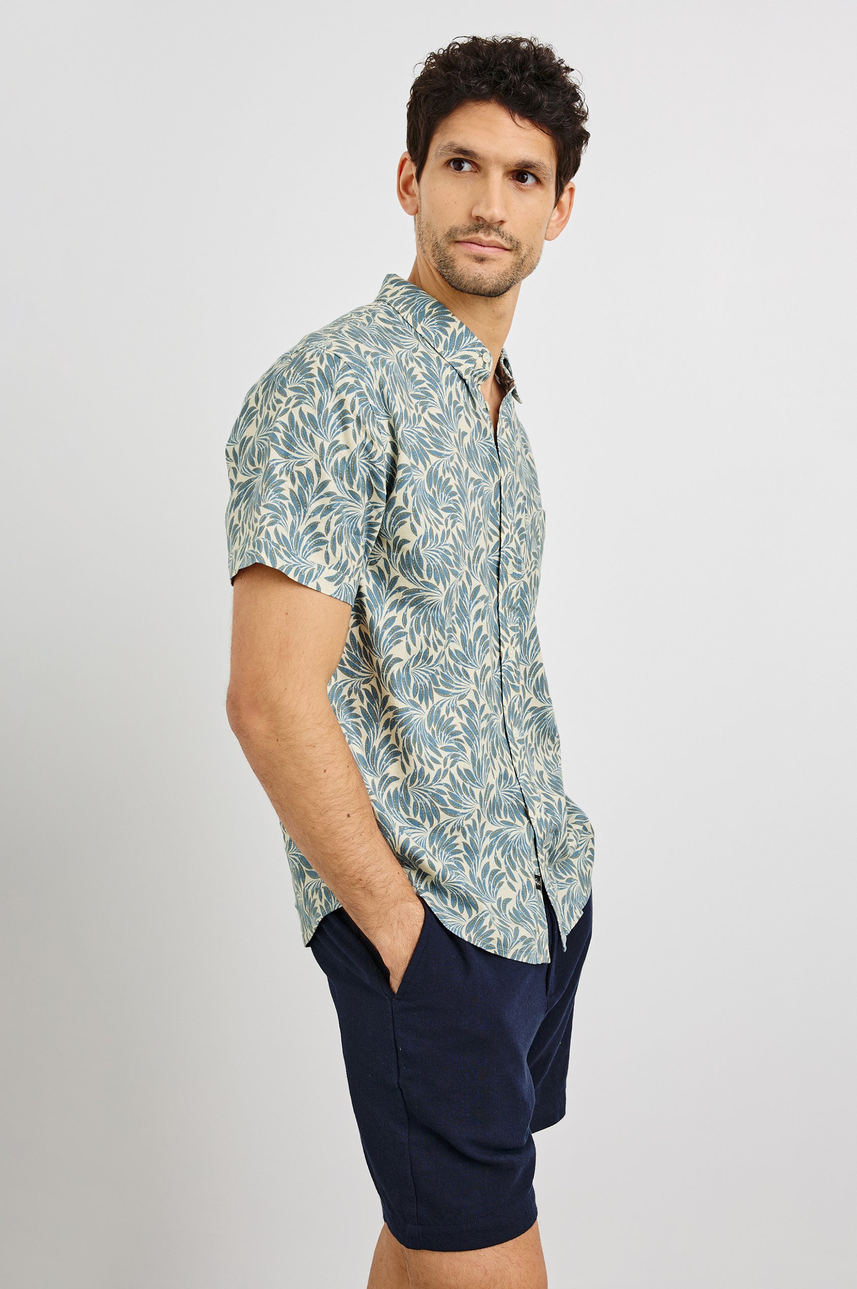Carson Collared Button Front Shirt with Short Sleeves and a Chest Pocket in Ecru Banana Leaf Colorway. Side View Shown on Model.