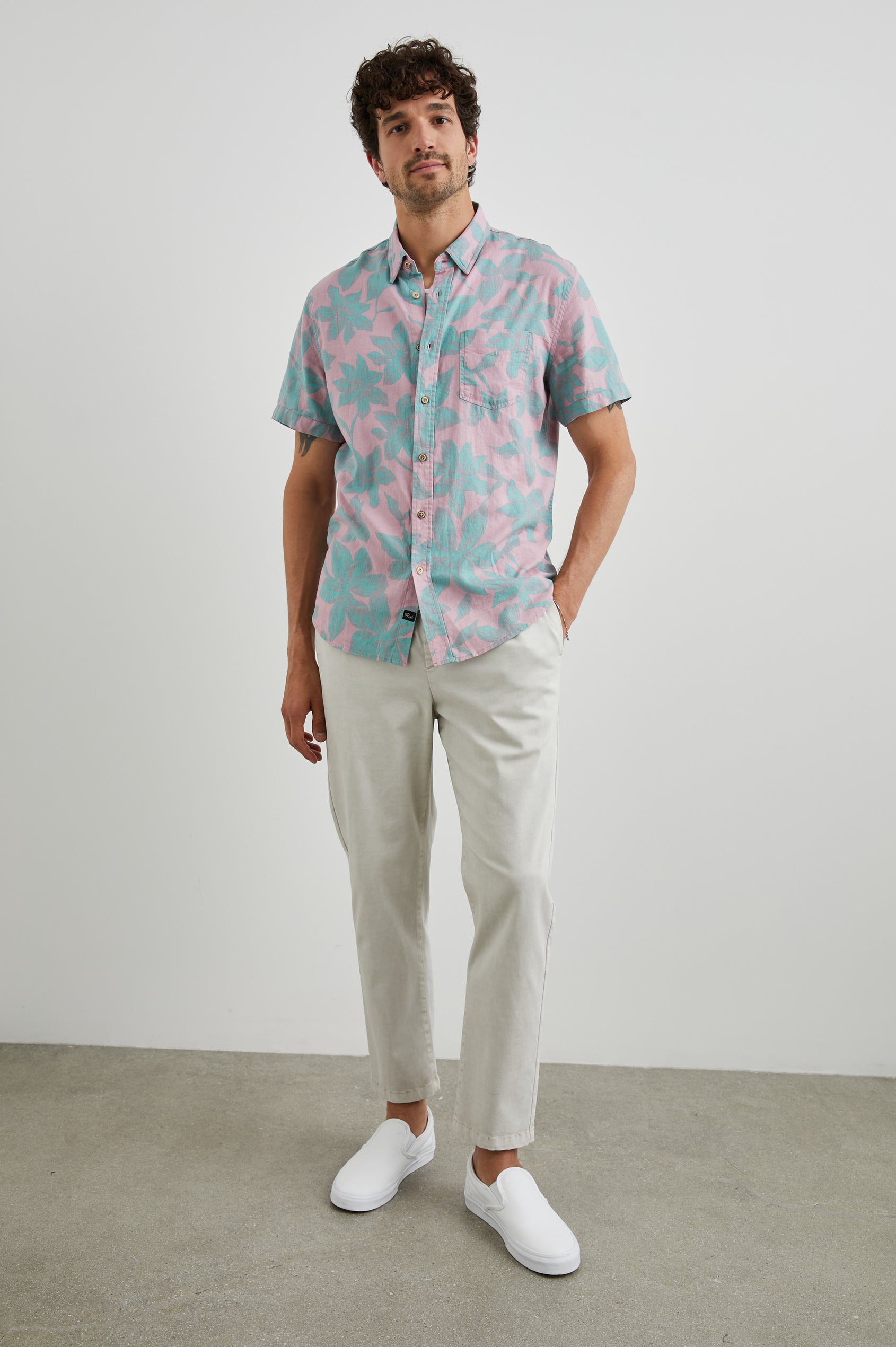 Carson Short Sleeve Button Up with a Chest Patch Pocket in Garden Sands Miami Colorway, Green Flowers on Pink - Front Full Body View Featured on Model