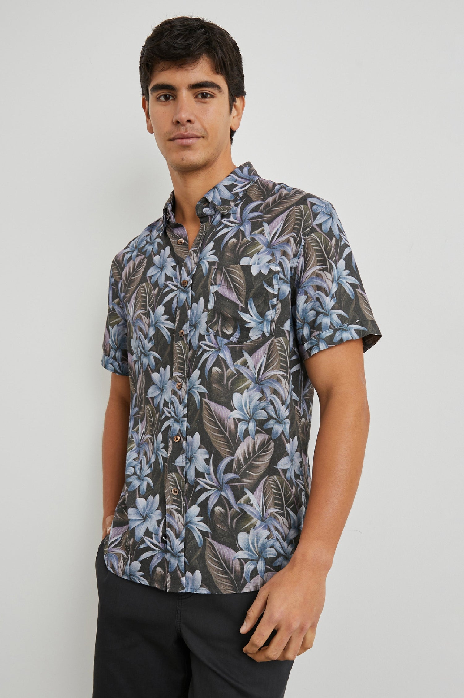Carson Short Sleeve Button Up with a Chest Patch Pocket in Jungle Garden Midnight Colorway, Flowers and Leaves in Blue and Olive on Midnight - Front View Featured on Model
