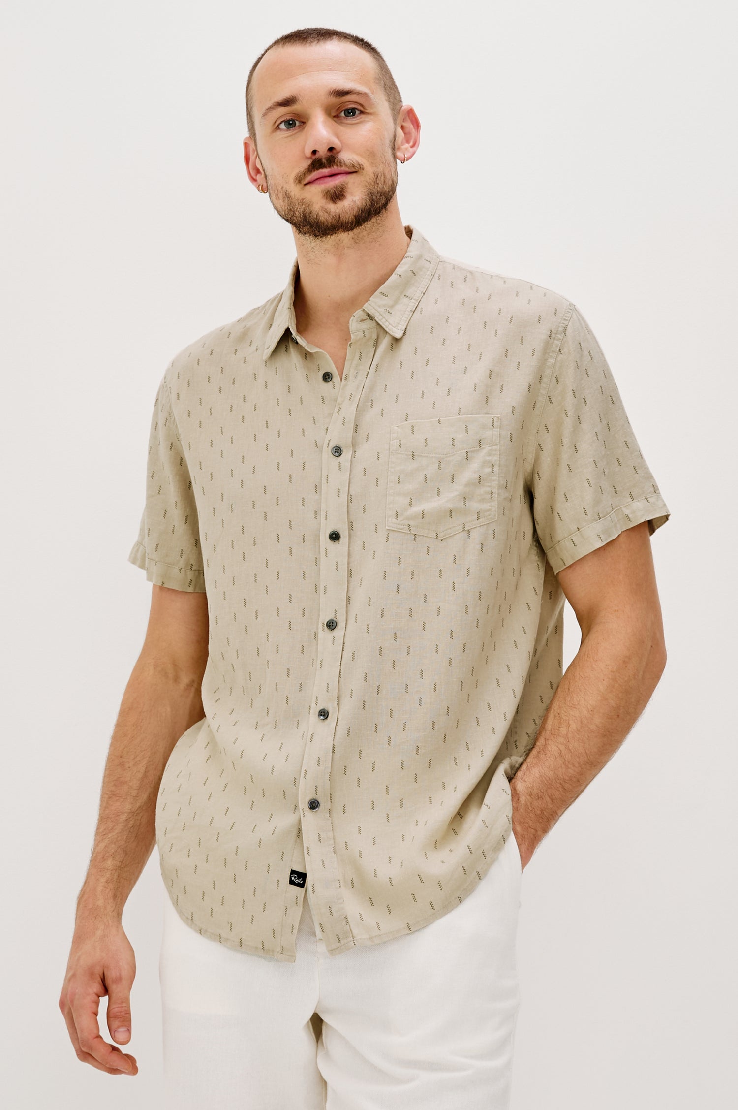 Carson linen short sleeve button down with a collar and front chest pocket in Louis Leaf Khaki colorway - front view on model