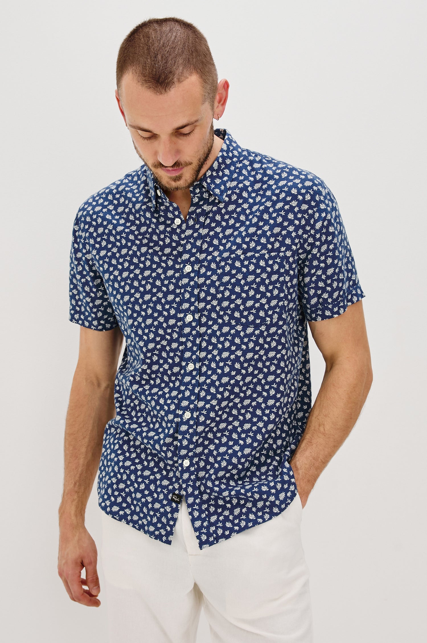 Carson Collared Button Front Shirt with Short Sleeves and a Chest Pocket in Nervous Leaf Blue Colorway. Front View Shown on Model.