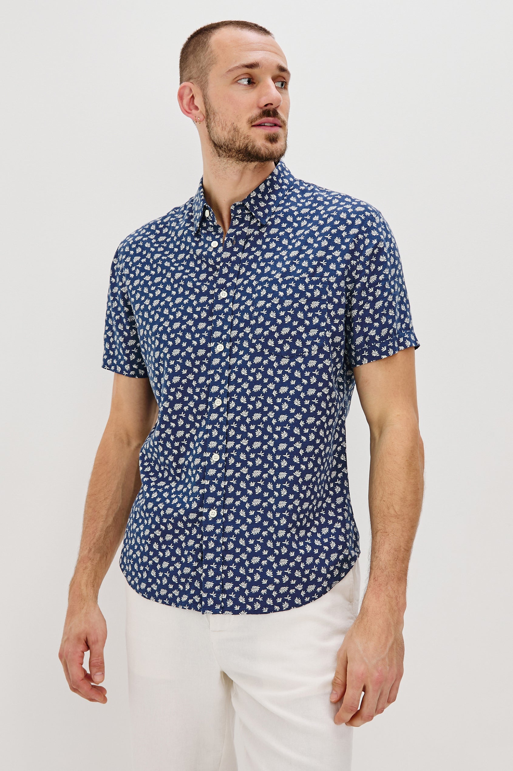 Carson Collared Button Front Shirt with Short Sleeves and a Chest Pocket in Nervous Leaf Blue Colorway. Front View Shown on Model.