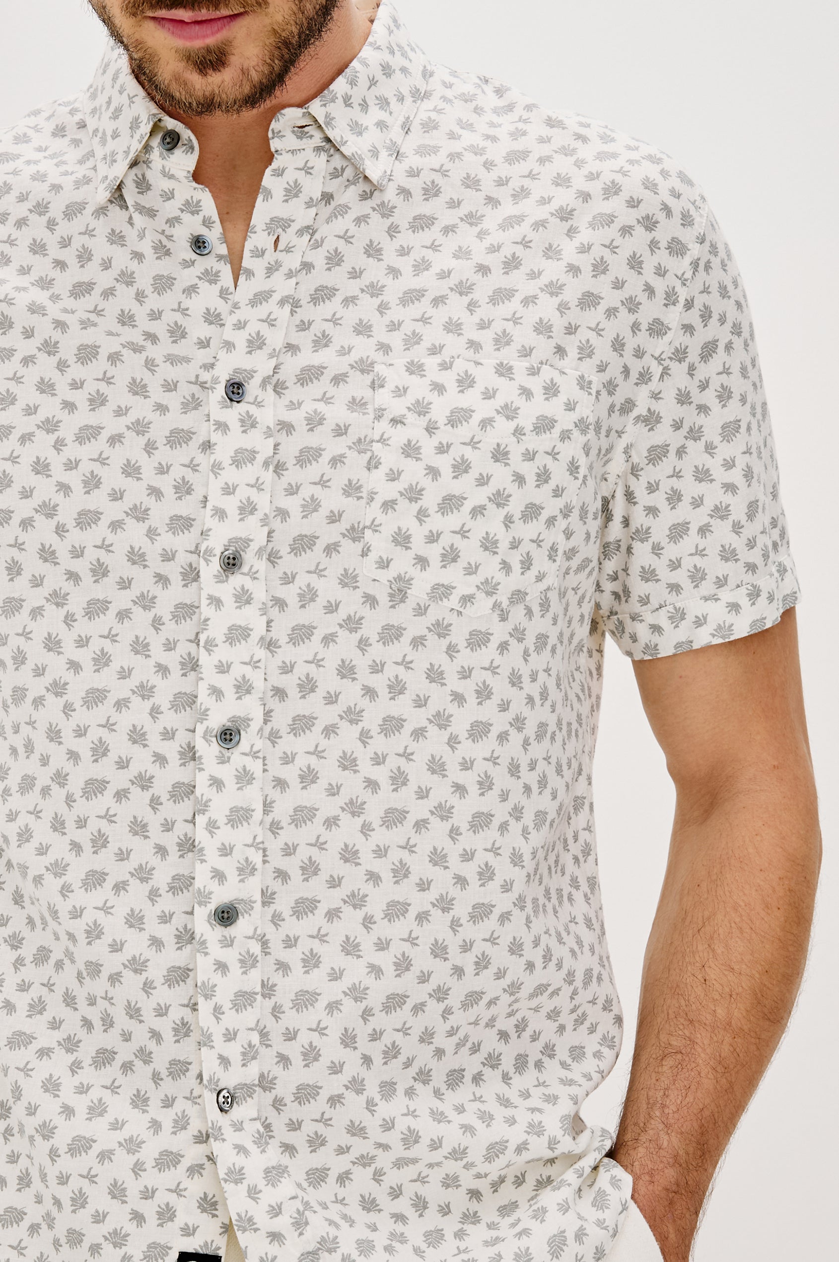 Carson Collared Button Front Shirt with Short Sleeves and a Chest Pocket in Nervous Leaf White Colorway. Front Detail View Shown on Model.