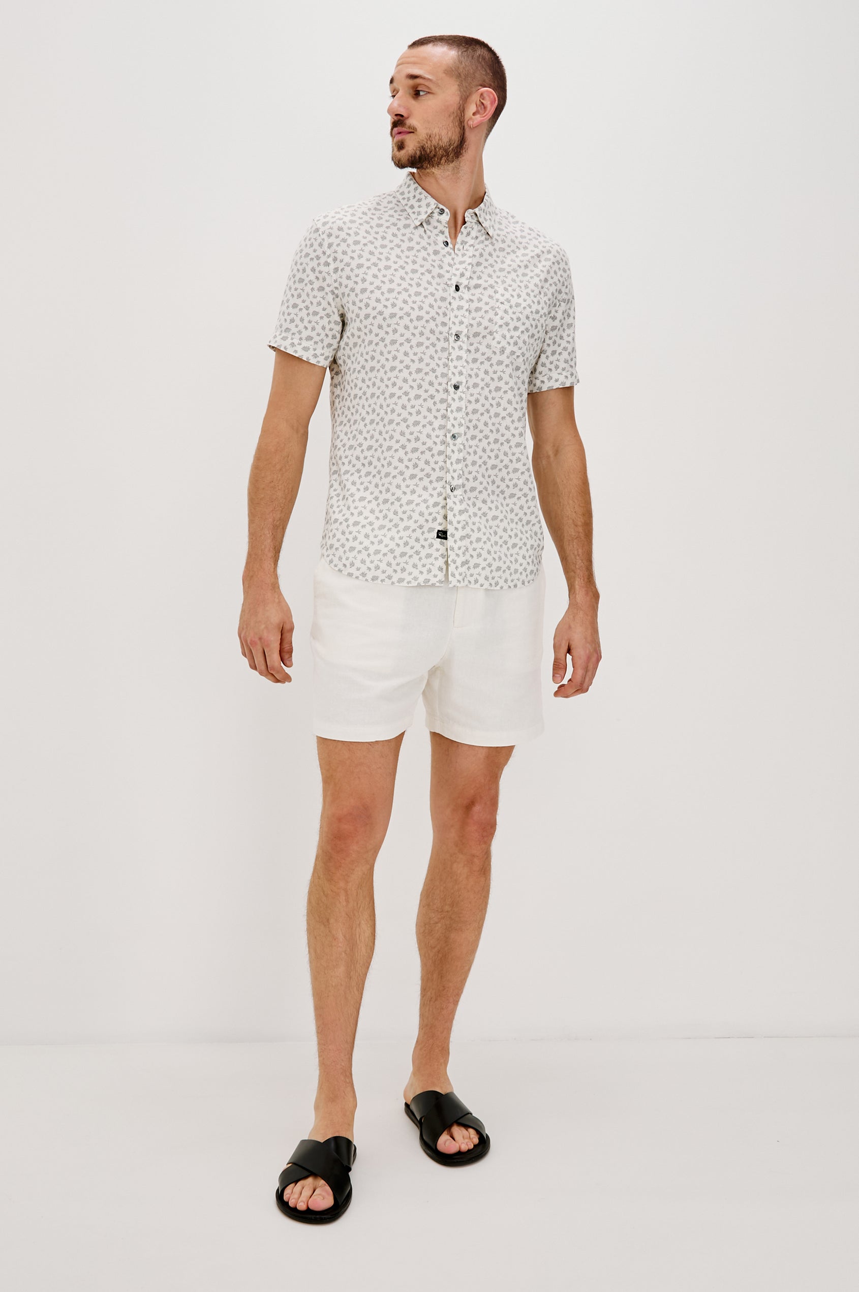 Carson Collared Button Front Shirt with Short Sleeves and a Chest Pocket in Nervous Leaf White Colorway. Full Body Front View Shown on Model.