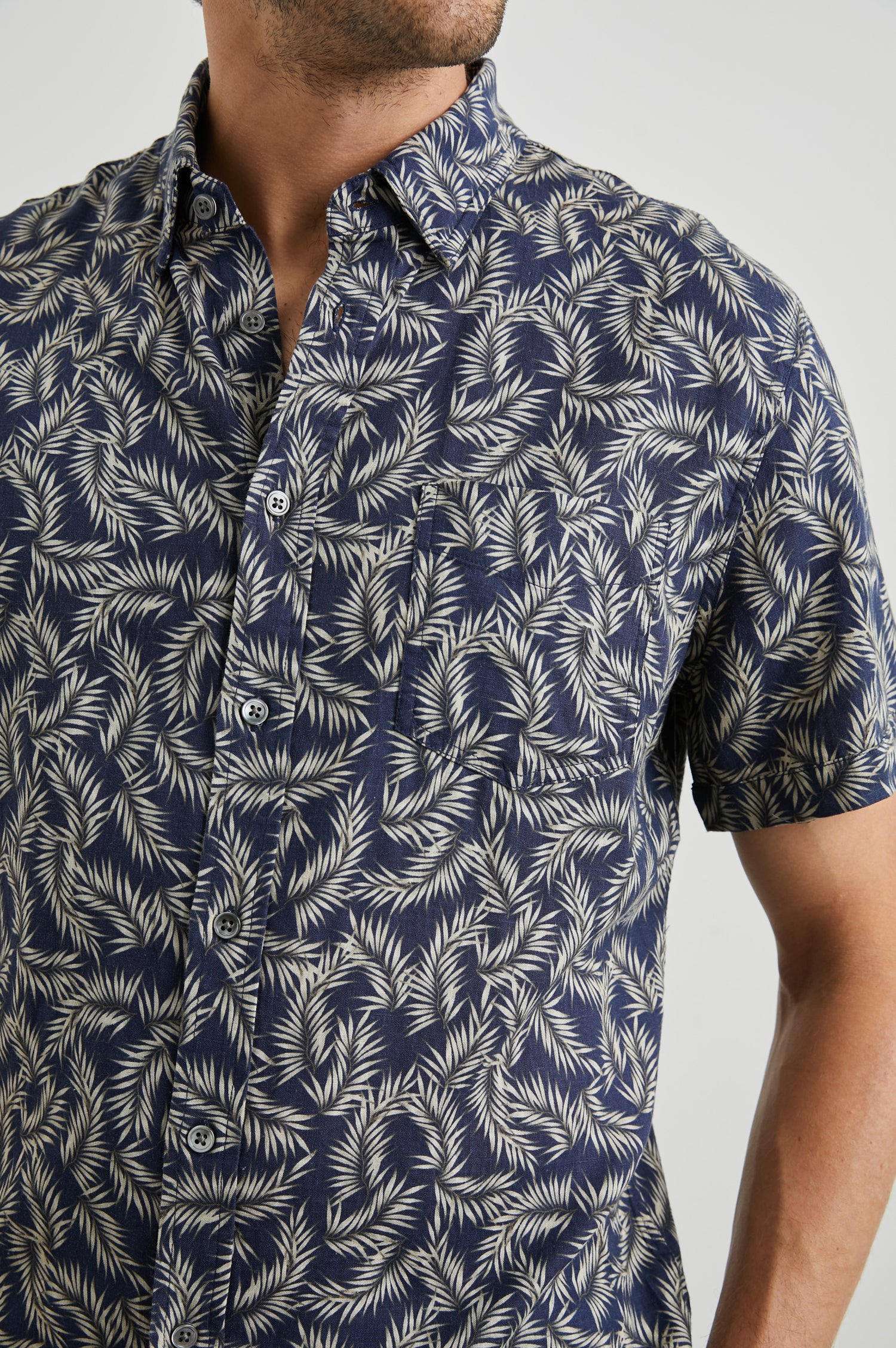 Carson Short Sleeve Button Up with a Chest Patch Pocket in Palm American Navy Colorway, Tan Fronds on Navy - Front View Featured on Model