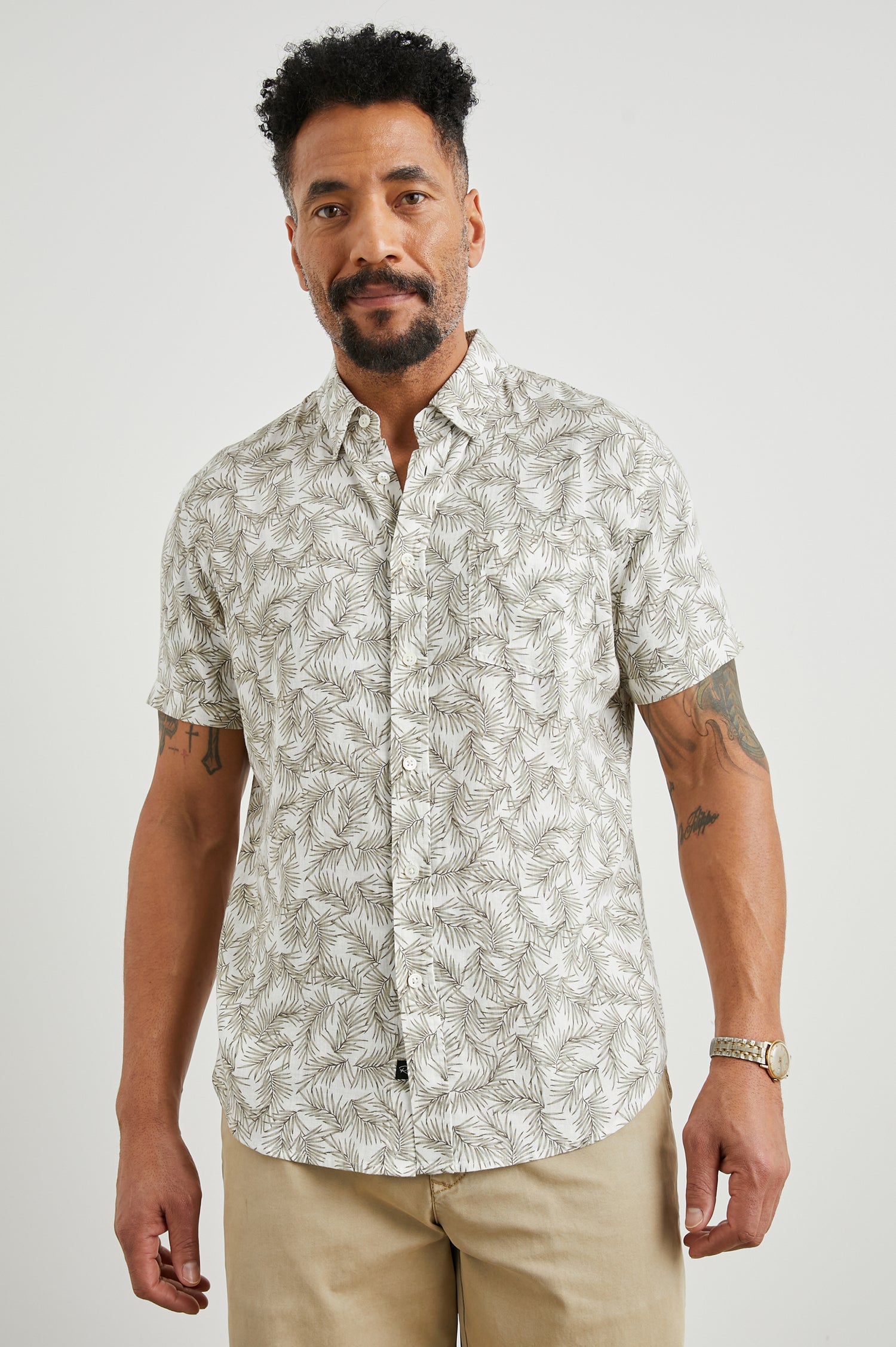 Carson Short Sleeve Button Up with a Chest Patch Pocket in Palm American White Colorway, Olive Fronds on White - Front View Featured on Model