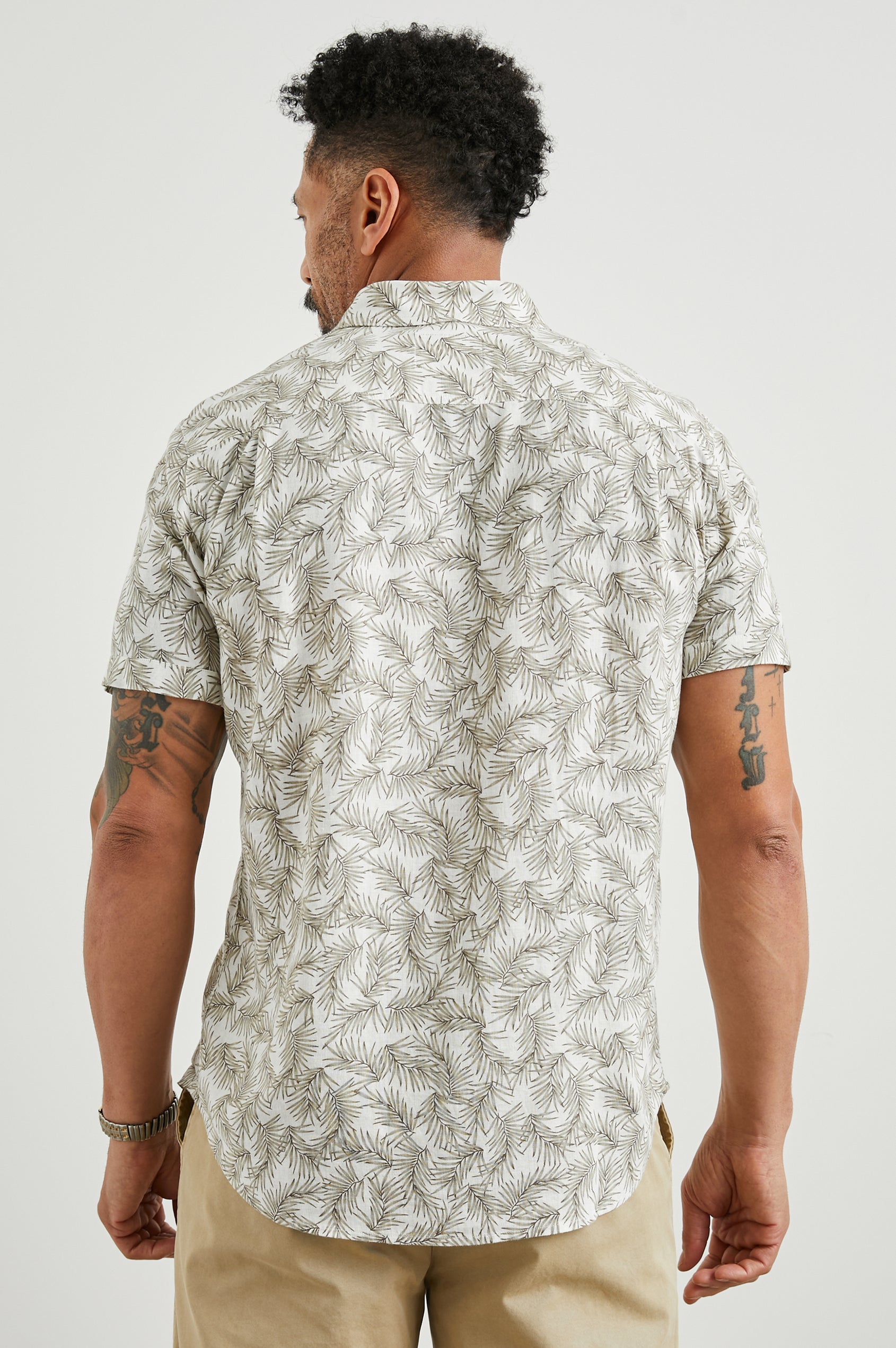 Carson Short Sleeve Button Up with a Chest Patch Pocket in Palm American White Colorway, Olive Fronds on White - Back View Featured on Model