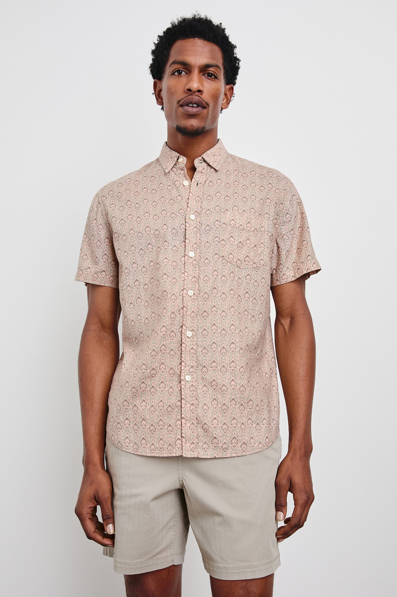 Carson linen short sleeve button down with a collar and ornamental pattern in Batik Flamingo - front view on model