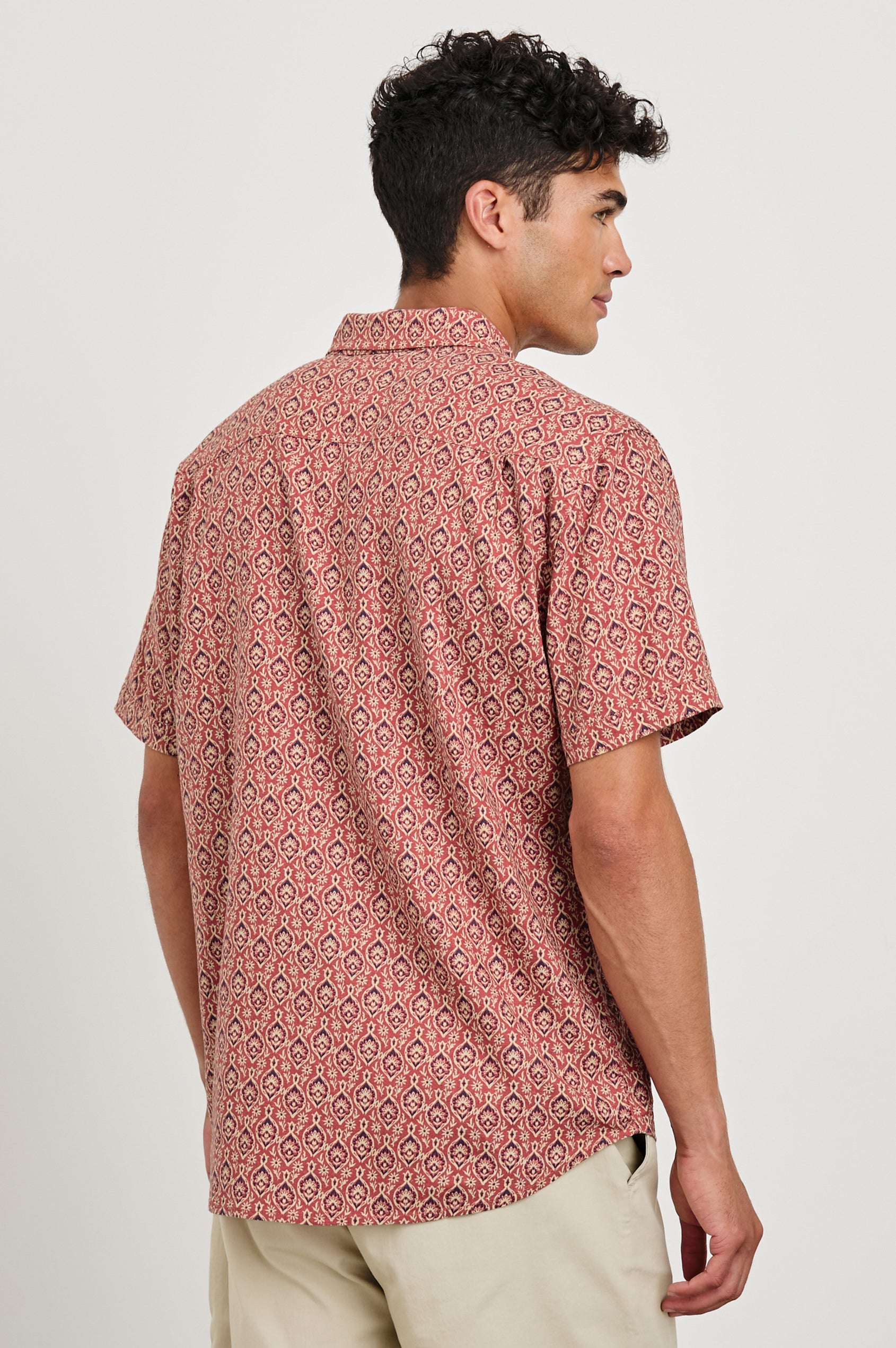 Carson linen short sleeve button down with a collar and ornamental pattern in Batik Rose - back view on model