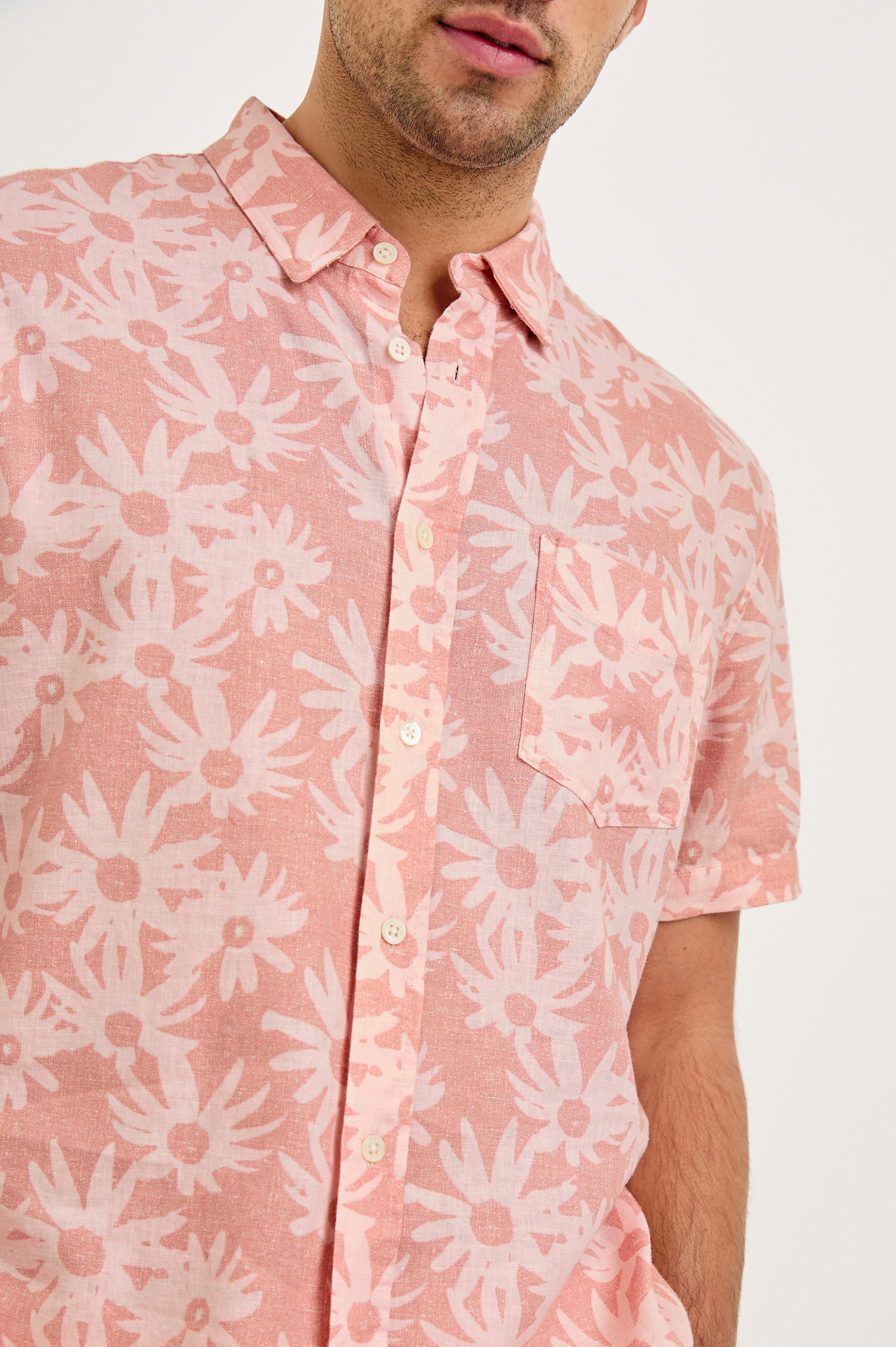 Carson linen short sleeve button down with a collar and floral pattern in Perennial Pink - close up of details on model